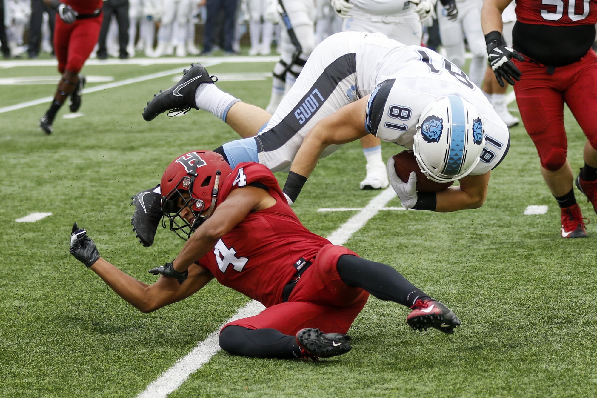 Harvard's defense limited Columbia to 305 total yards. Here, sophomore Max Jones upends tight end Rory Schlageter.