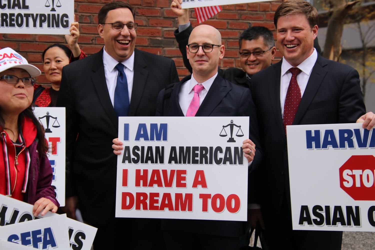 Students for Fair Admissions lawyers pose for pictures outside the courthouse.