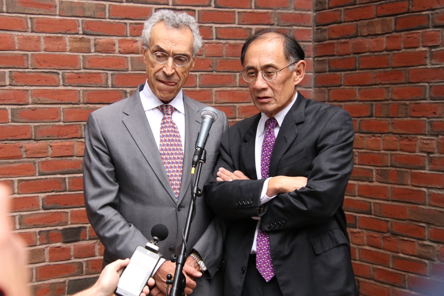 Harvard lawyers Seth P. Waxman '73 and William F. Lee '72 speak to reporters outside the courthouse on the trial's final day.
