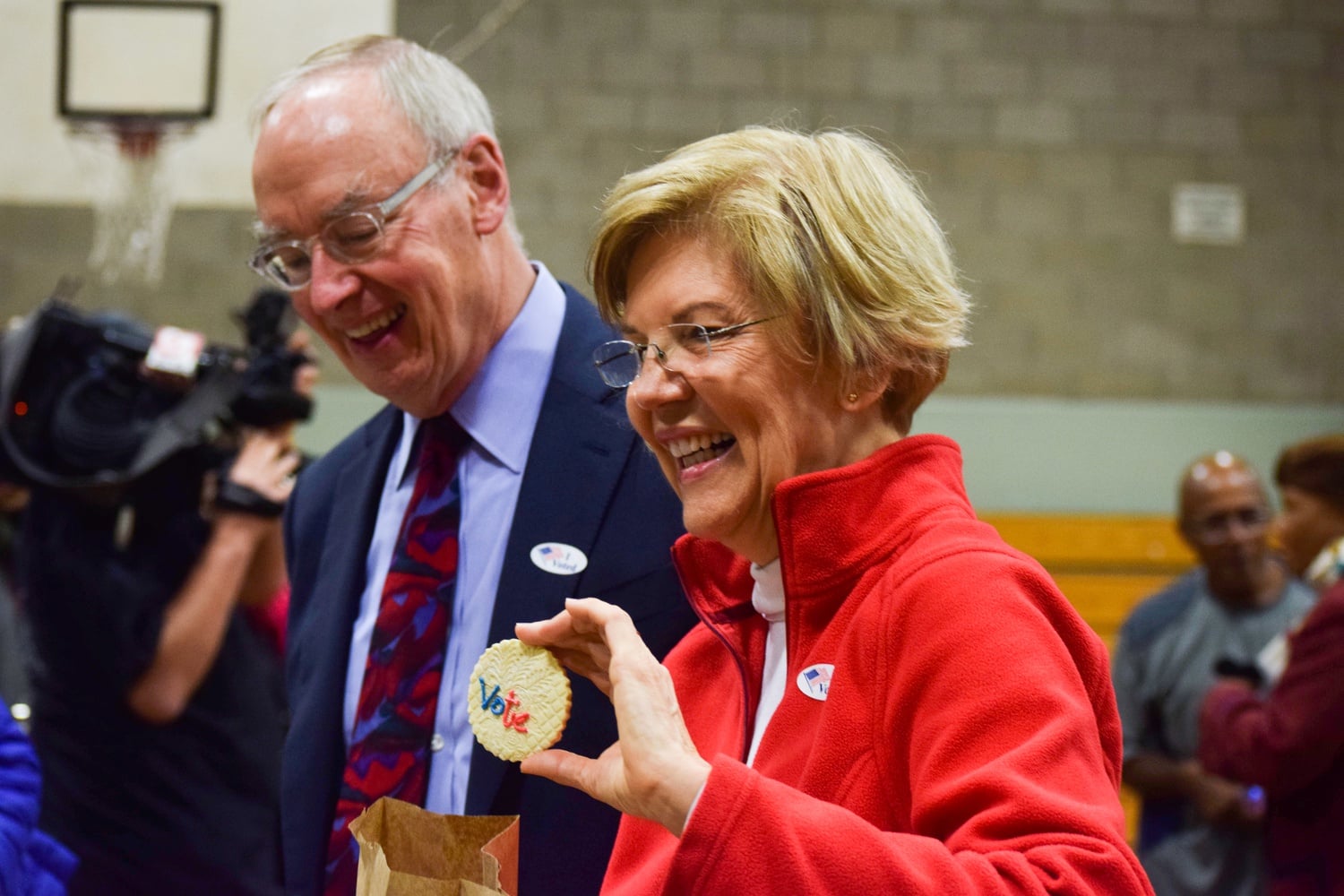 Senator Elizabeth Warren buys cookies at a 5th grade bake sale after voting Tuesday morning at a local elementary school.