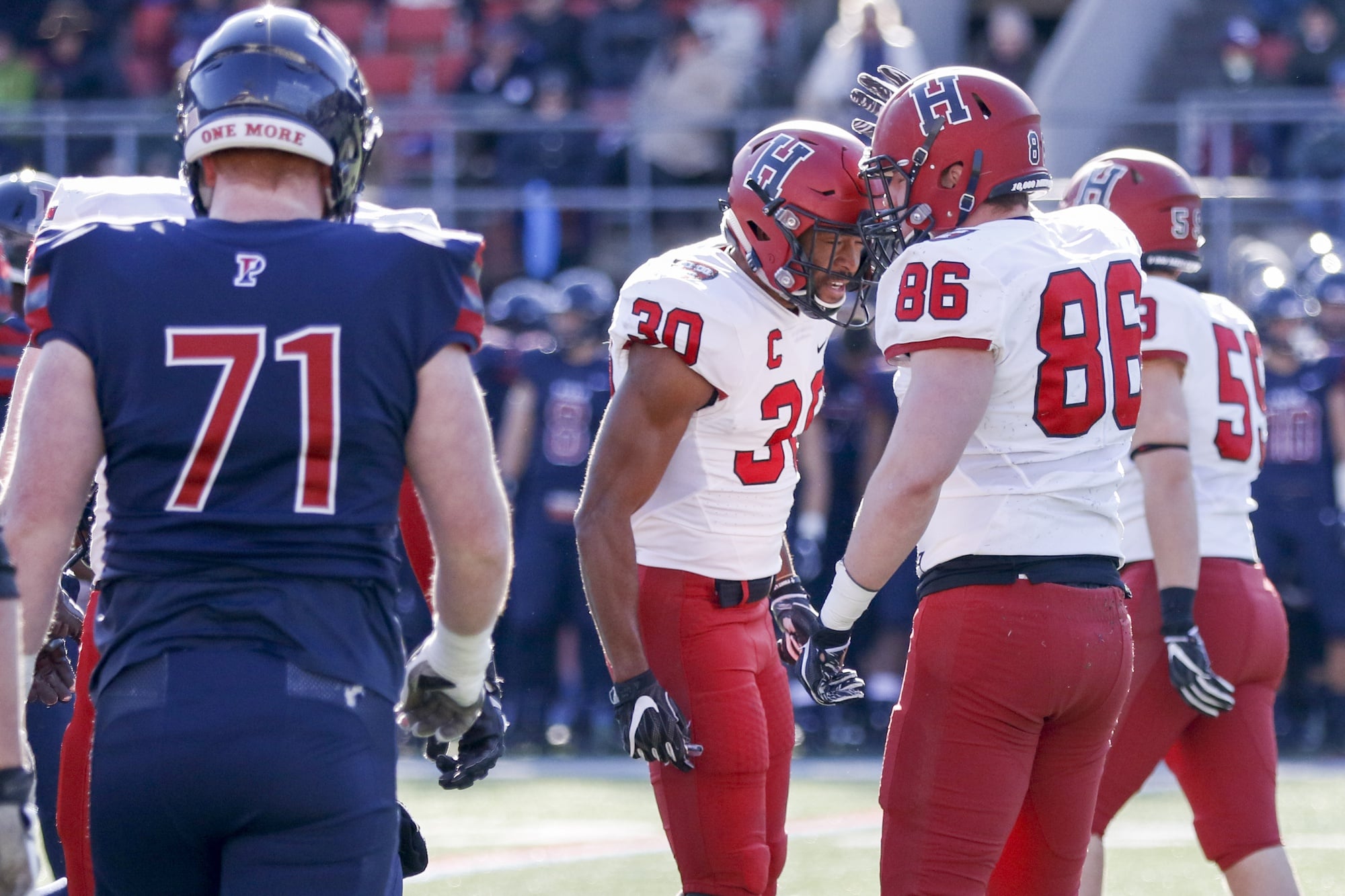 Captain and safety Zach Miller celebrates with senior defensive end John Pirrmann after a stop. Today's win was the first for the senior class against Penn.