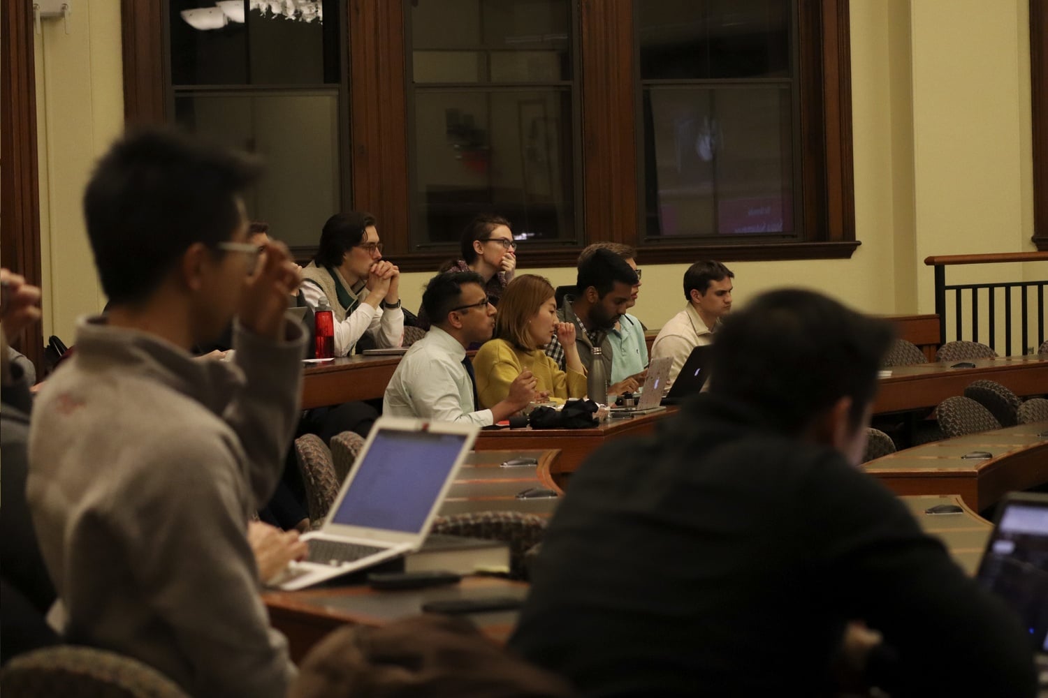 People gather in classrooms on the first floor of Austin Hall Tuesday night to watch a live stream of the final round of the Ames Competition, which was taking place a floor above.
