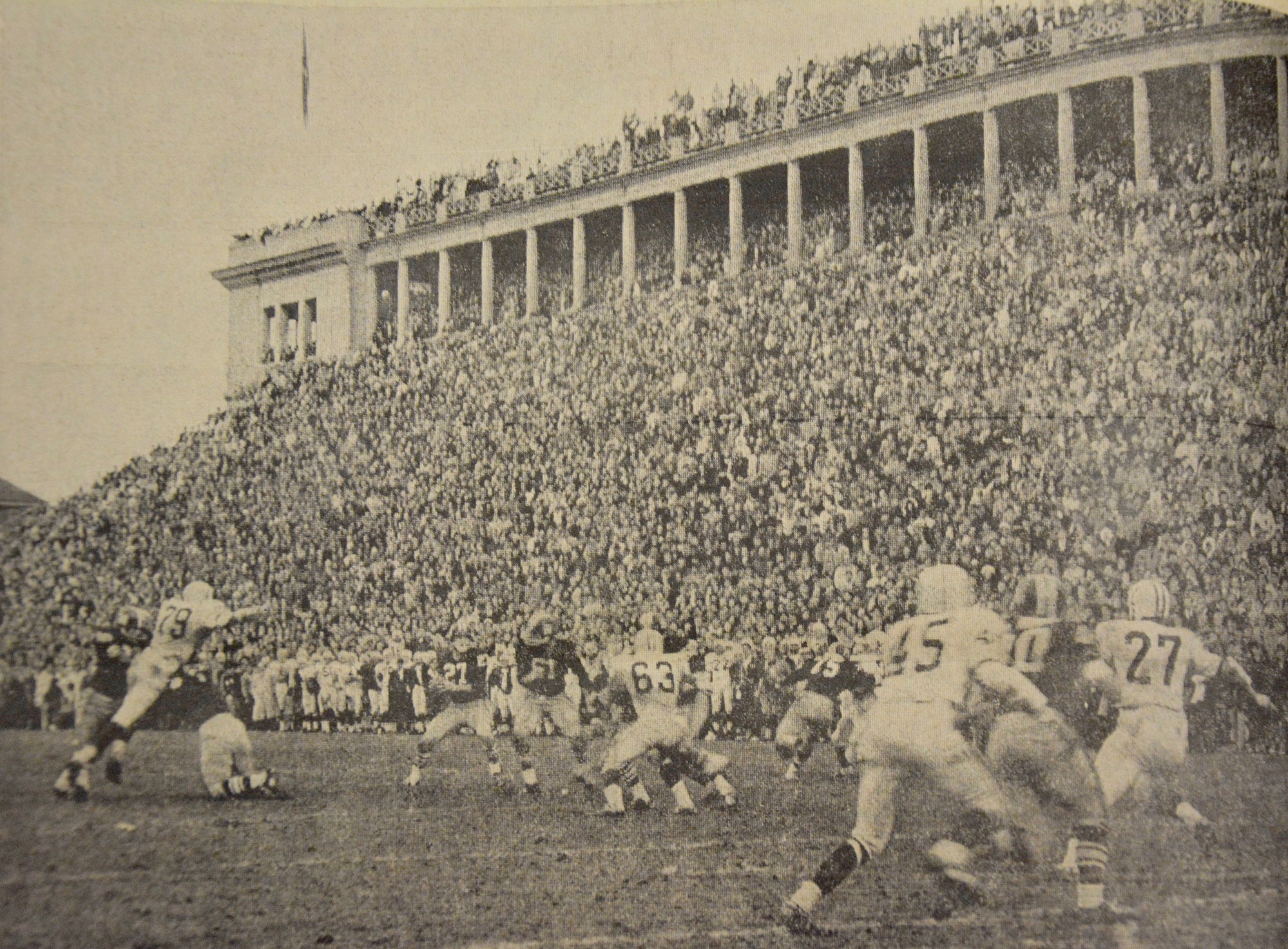 Frank Champi (27) sets himself to deliver a pass on the game's last play.