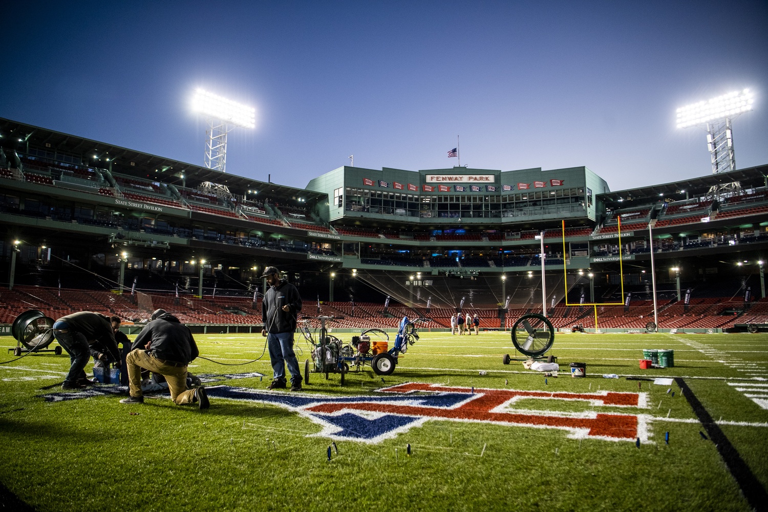 Fenway's grounds crew puts the finishing touches on the converted baseball field ahead of The Game.