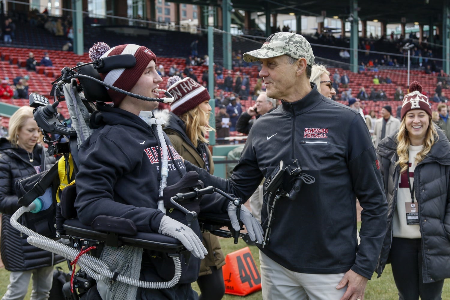 Defensive back Ben M. Abercrombie '21 (left) and head coach Tim Murphy (right) talk on the field. Since suffering a serious spinal injury last year, Abercrombie has worked hard at recovery at his home in Alabama.