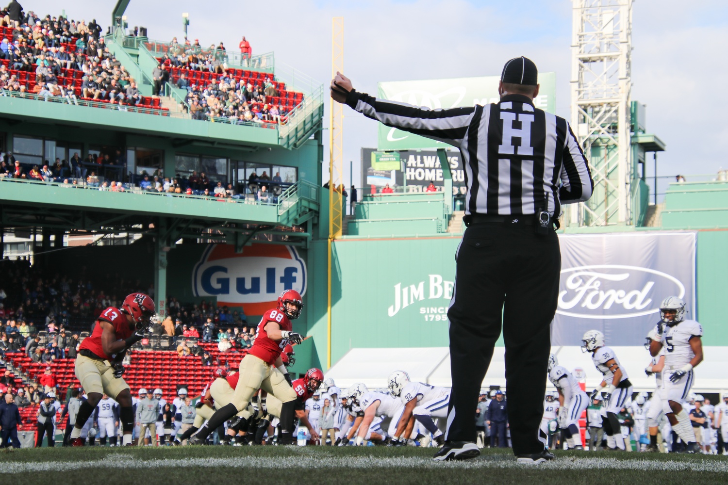 A member of the officiating crew motions before the start of a play during the 135th playing of The Game.