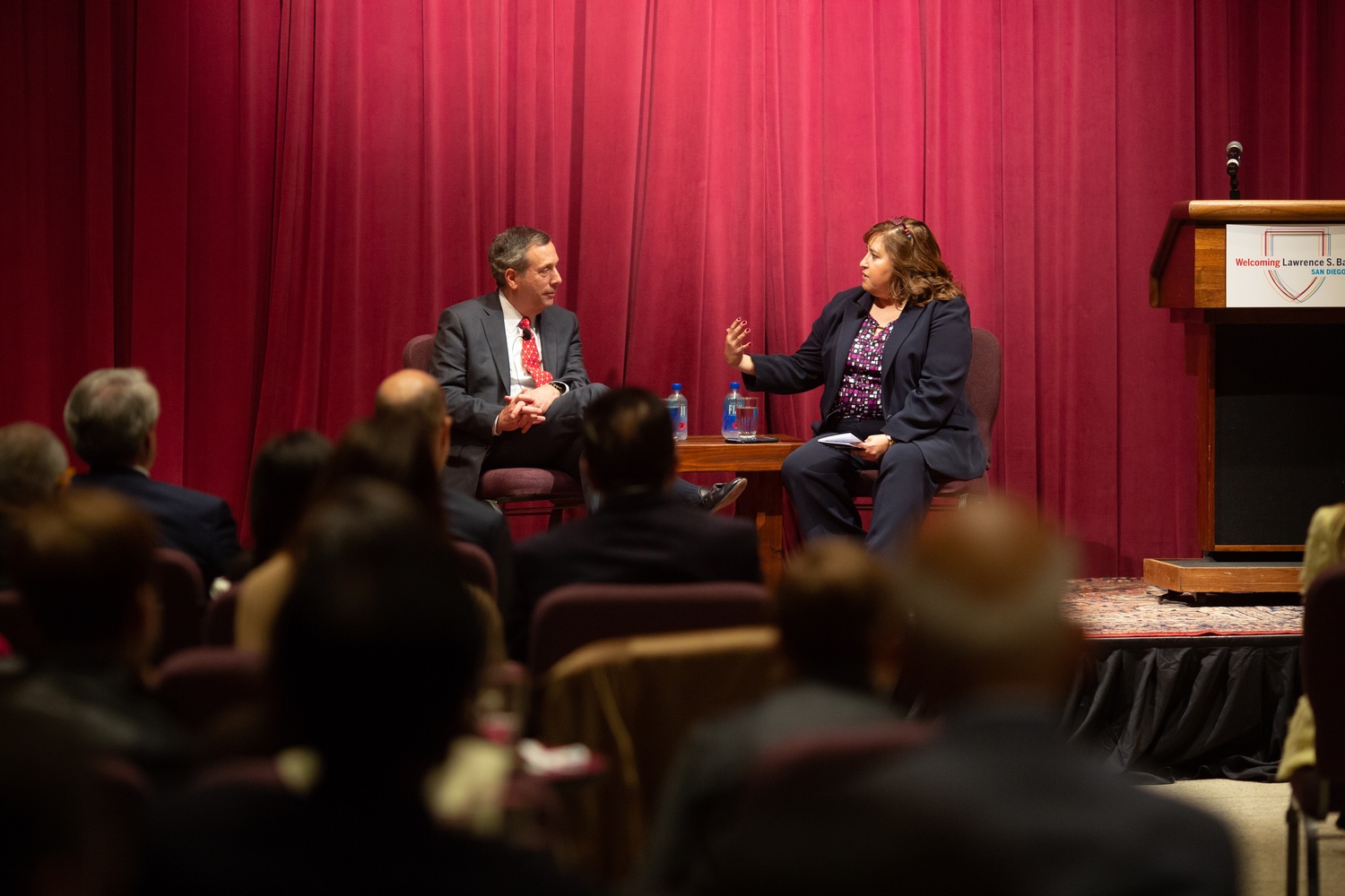 Yvonne Campos, a law school alum, mediates a discussion with President Bacow at the Harvard Alumni event at the San Diego Museum of Art.