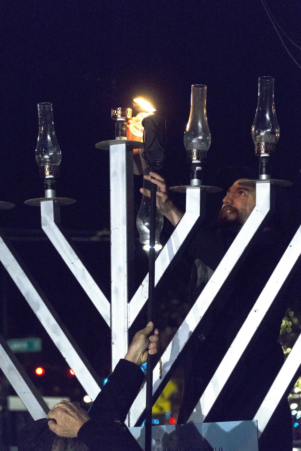 Harvard students and Cantabrigians gathered at Cambridge Commons to hold “a show of unity” after a man toppled the Menorah on Sunday.