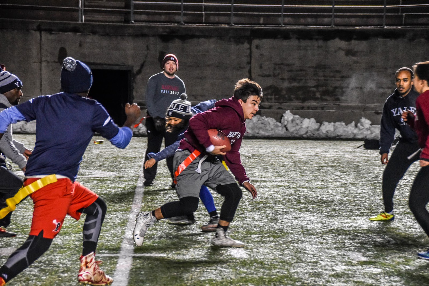 Harvard’s Raymond Hunt ‘21 drives down the field as he runs past the surrounding enemy players.