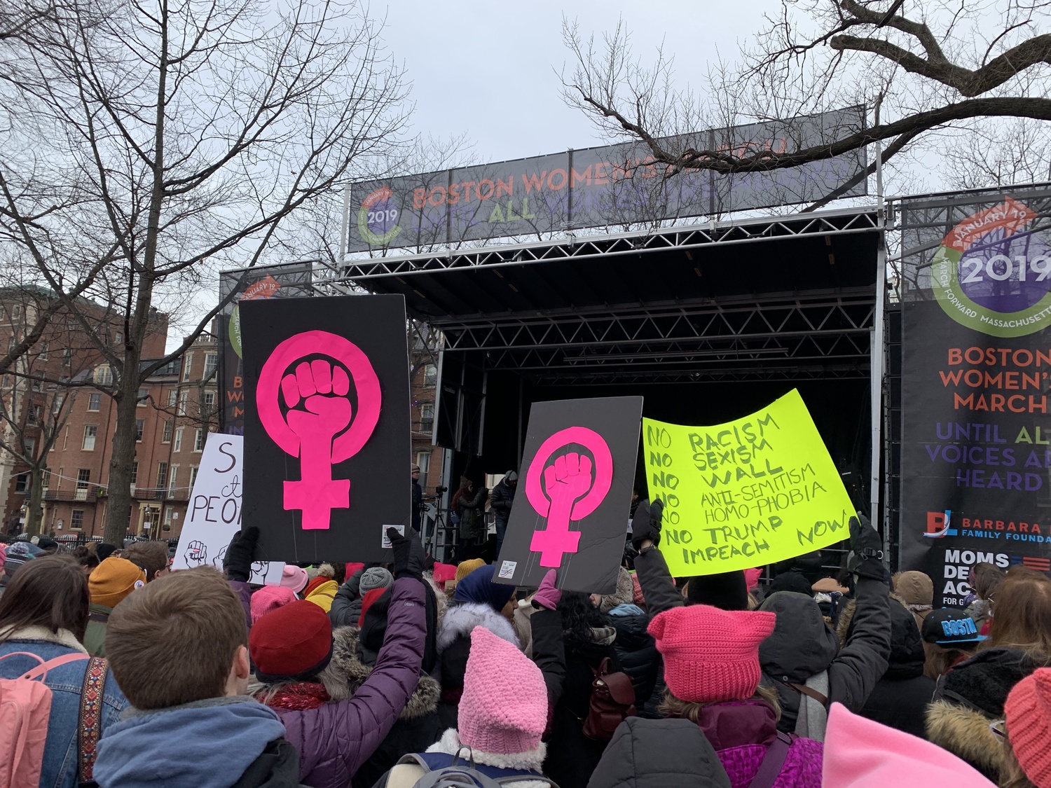 Attendees hold signs aloft as they listen to speakers at the Boston Women's March. Congresswoman Ayanna Pressley delivered the keynote speech.