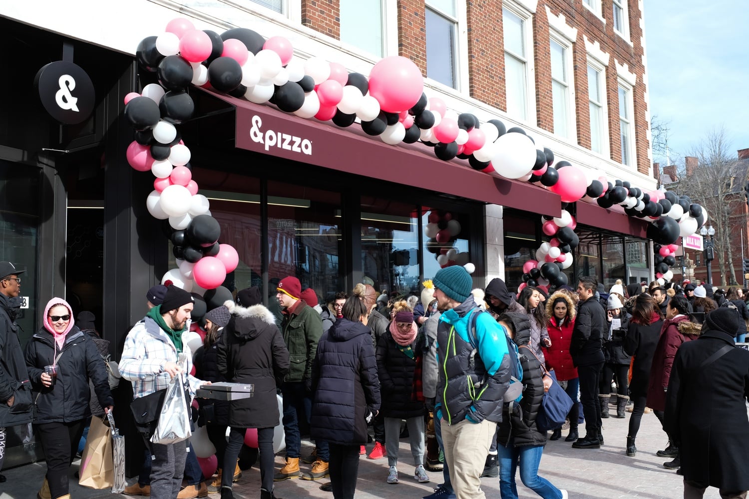 Hundreds lined up for the grand opening of Milk Bar and &pizza on Saturday, some waiting for hours to get in.