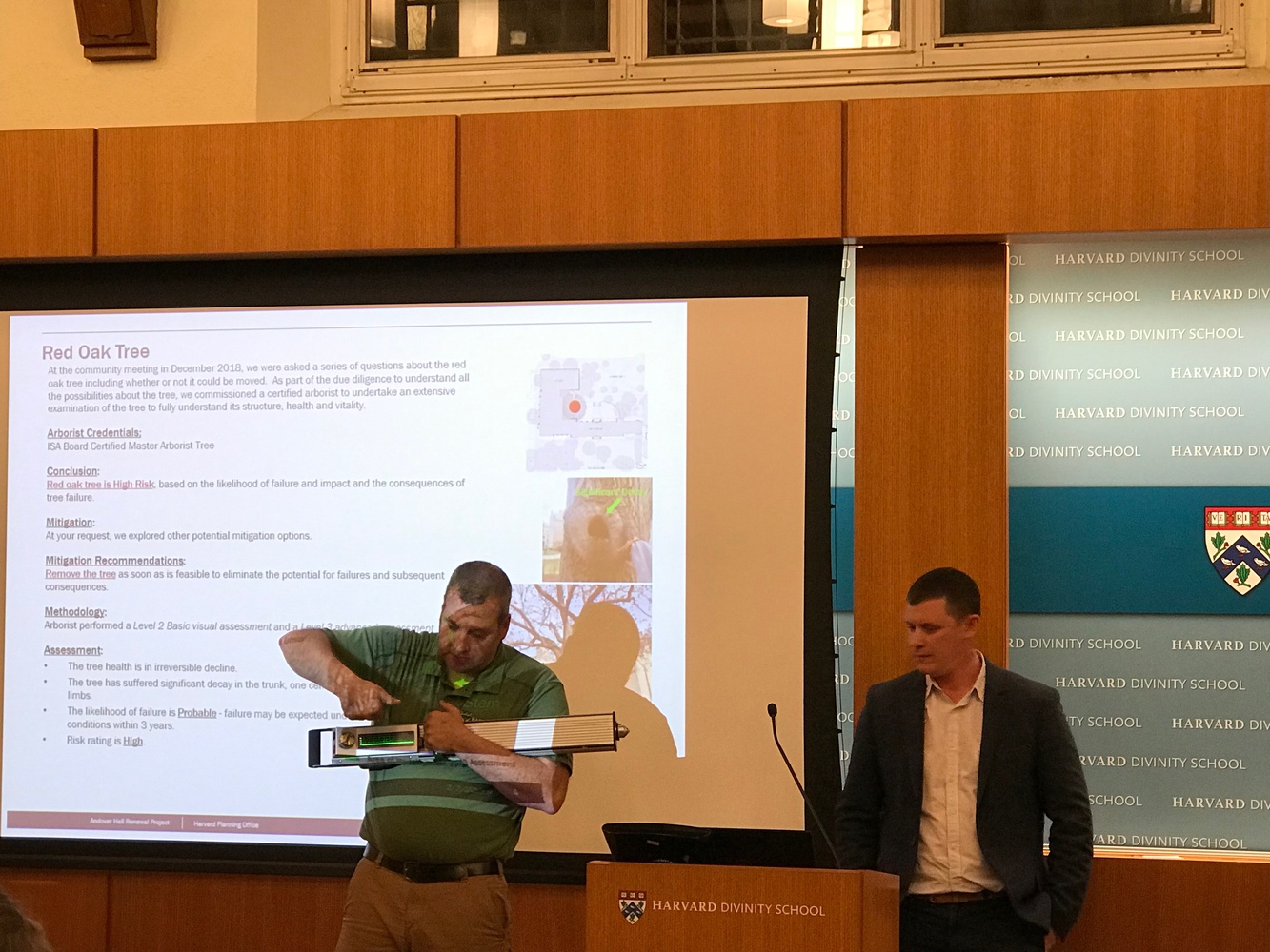 Timothy Armstrong, an arborist, gives a demonstration of the equipment used to evaluate a tree on Harvard Divinity School's grounds.