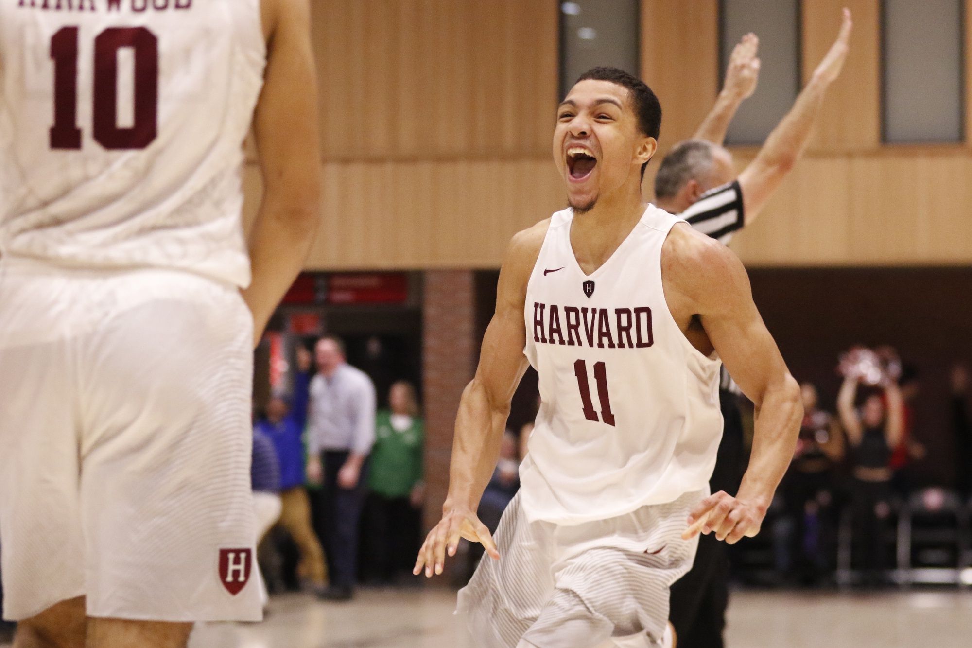 Junior point guard Bryce Aiken celebrates after hitting an acrobatic three-pointer to force a second overtime against Columbia. Harvard went on to win 98-96 in three overtimes.