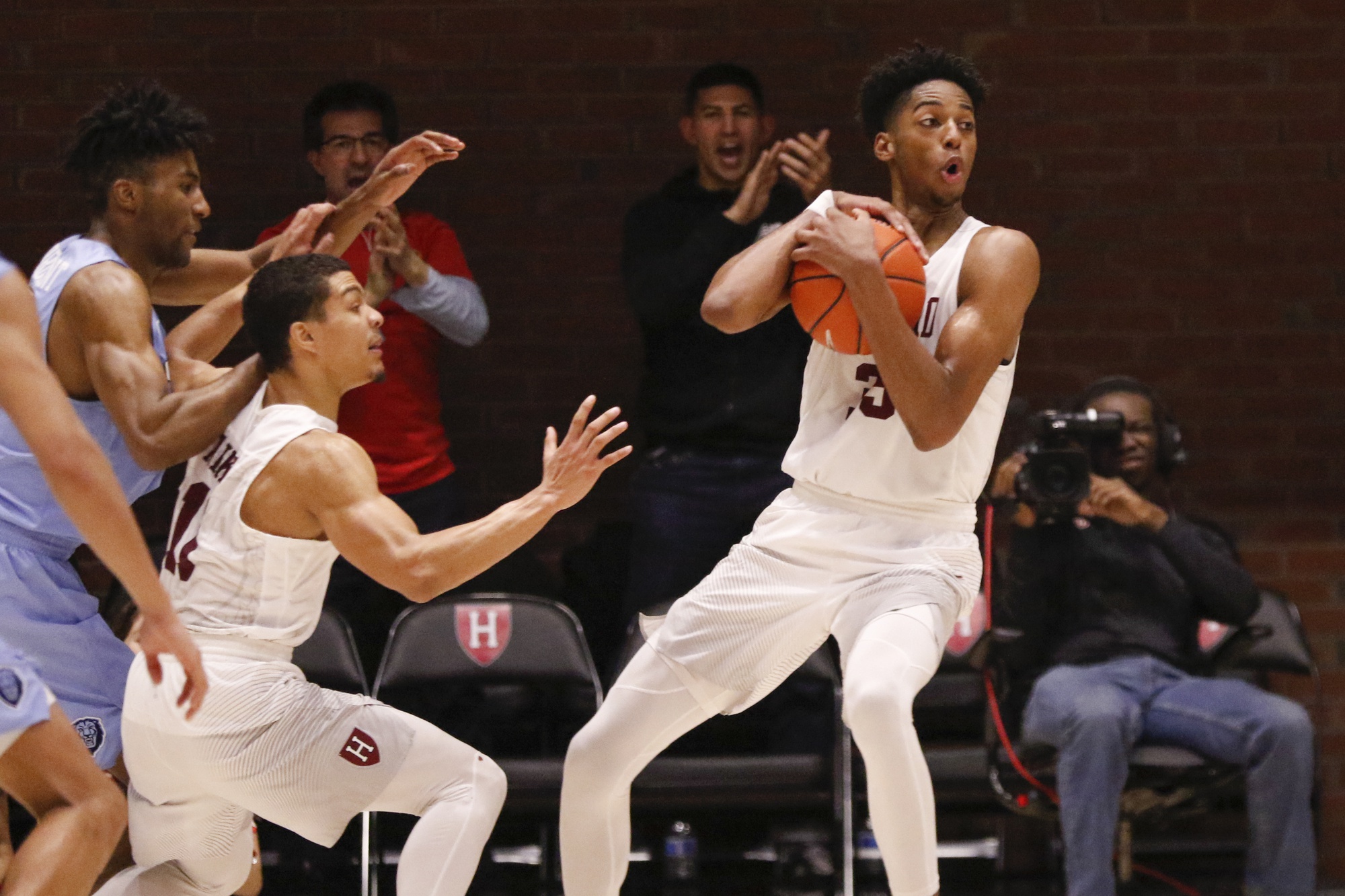 Baker grabs a critical rebound to help keep the Crimson ahead. The junior wing also had a critical block at the tail end of triple overtime.
