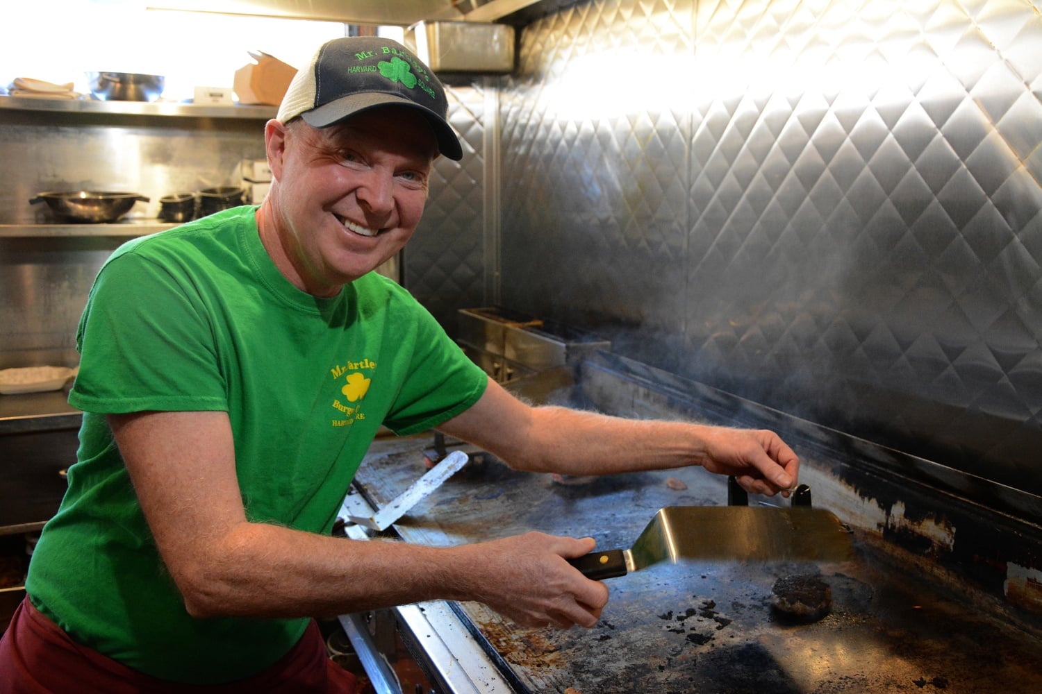 Busy with a thriving family business, Bill Bartley stands by the grill, flipping world-renowed burgers daily.