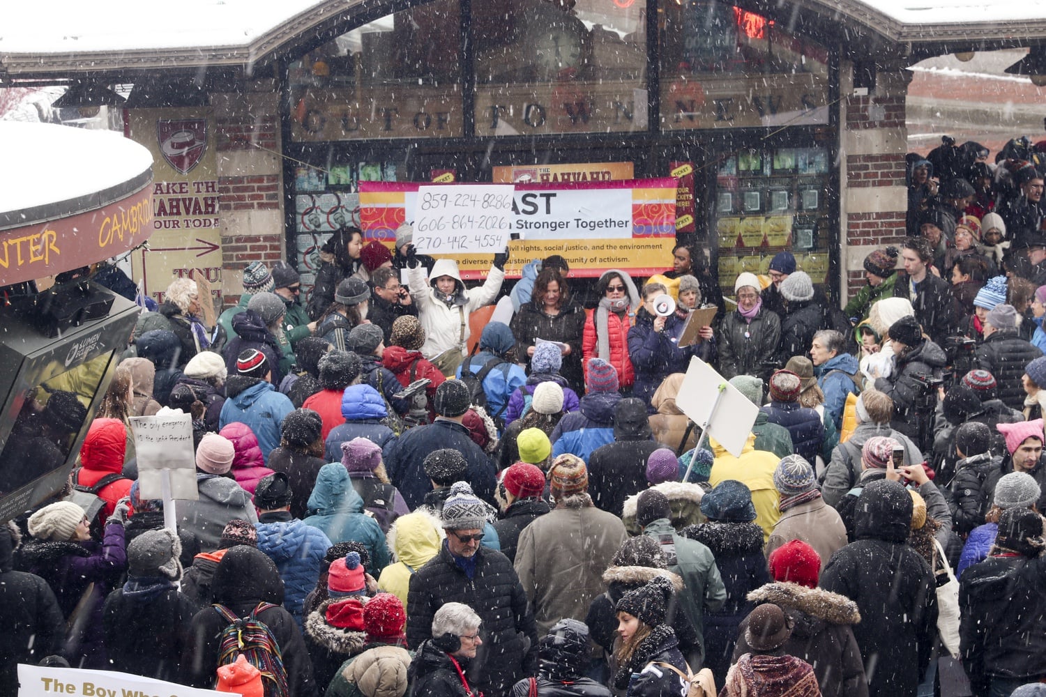 A crowd gathers near the Harvard Square Kiosk to protest President Donald Trump's declaration of a national emergency to build a wall at the country's southern border.