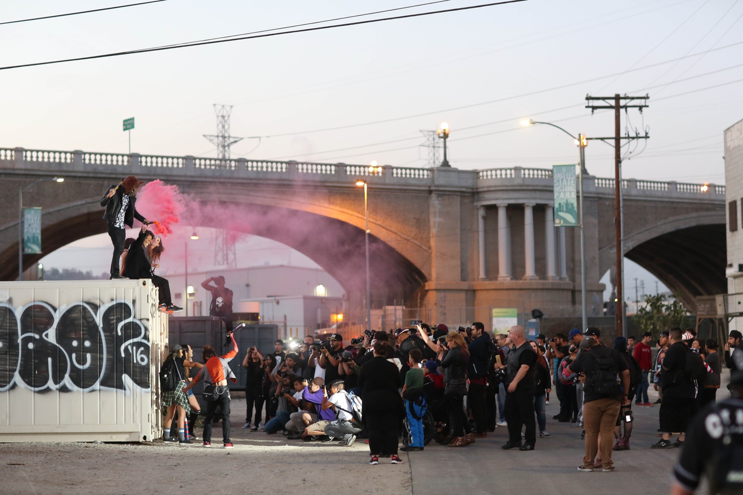 Photographers crowd around models at a photo meet in downtown Los Angeles.