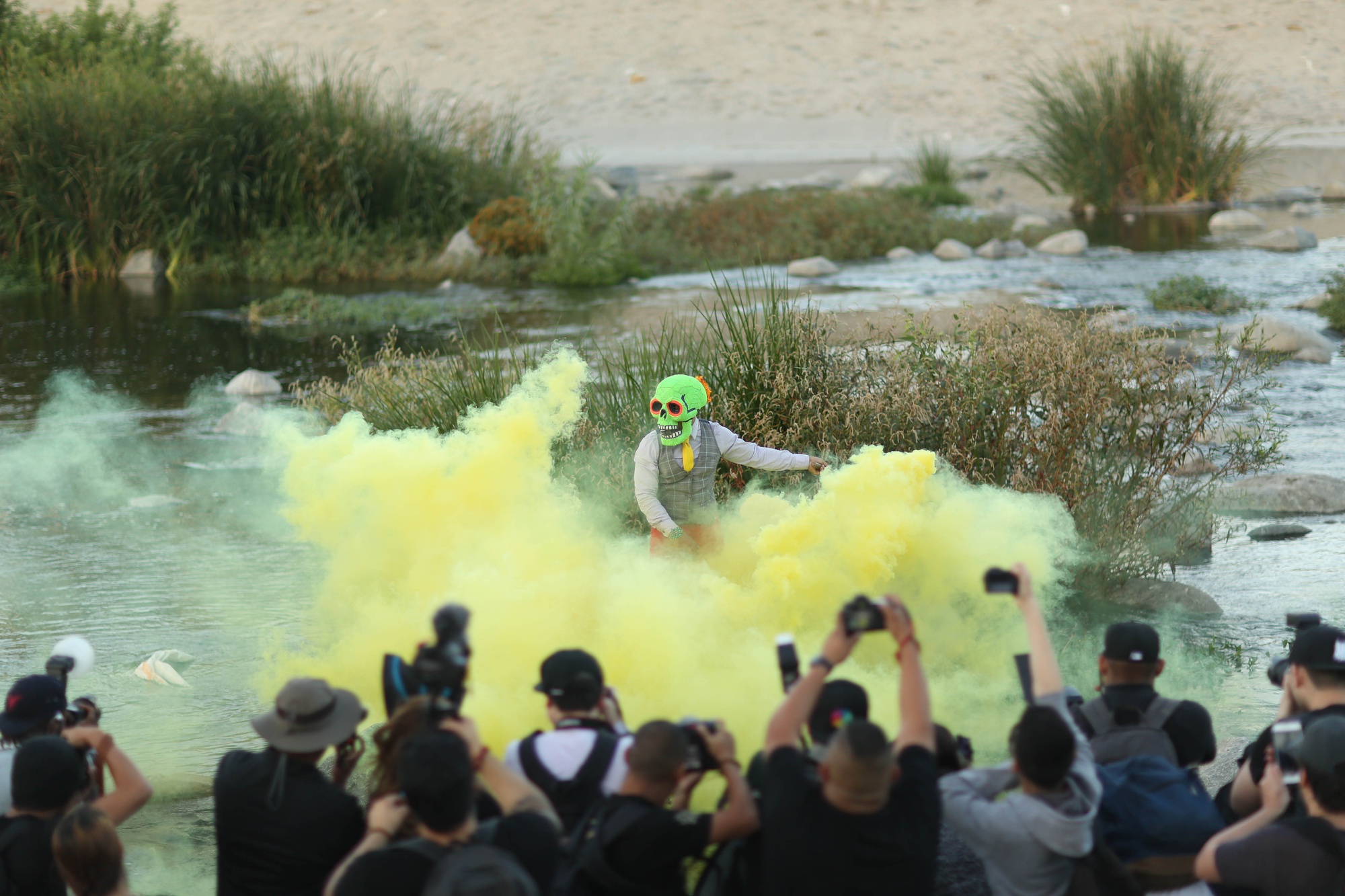 Butch waves a yellow smoke grenade in the Los Angeles River