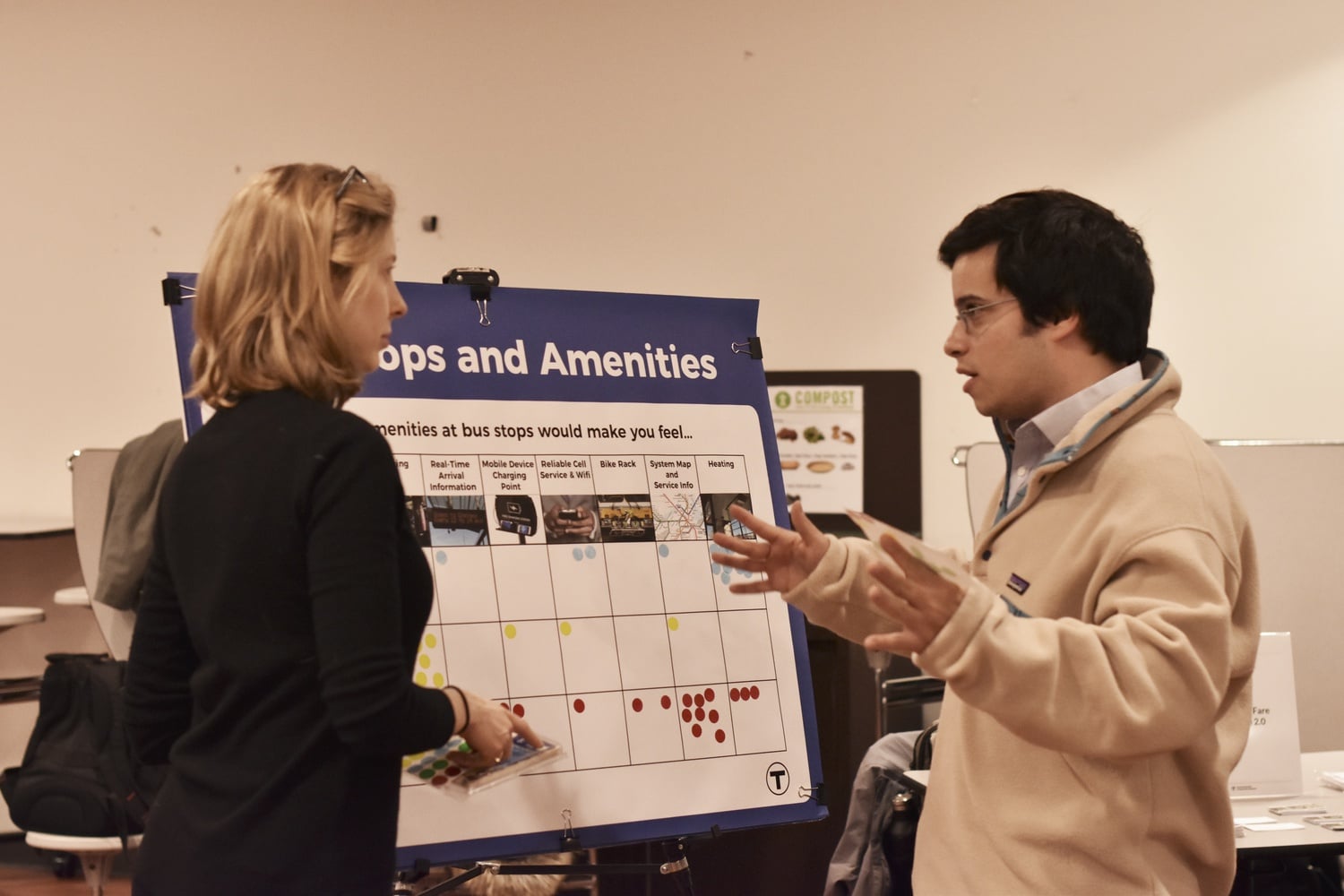 Daniel J. Totten (right) talks to a representative from the Massachusetts Bay Transit Authority about his concerns regarding proposed fare increases.