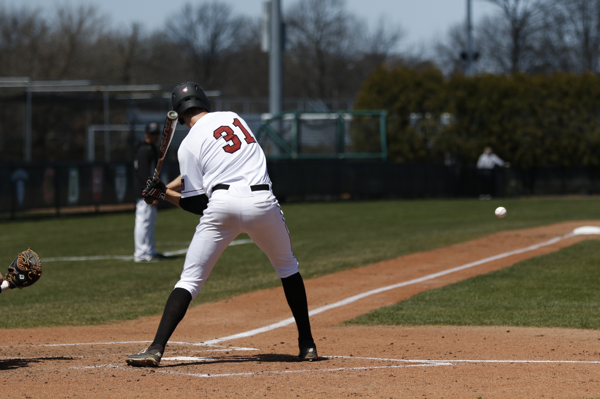 Senior 1B Pat McColl tees off on a pitch in action from last season.