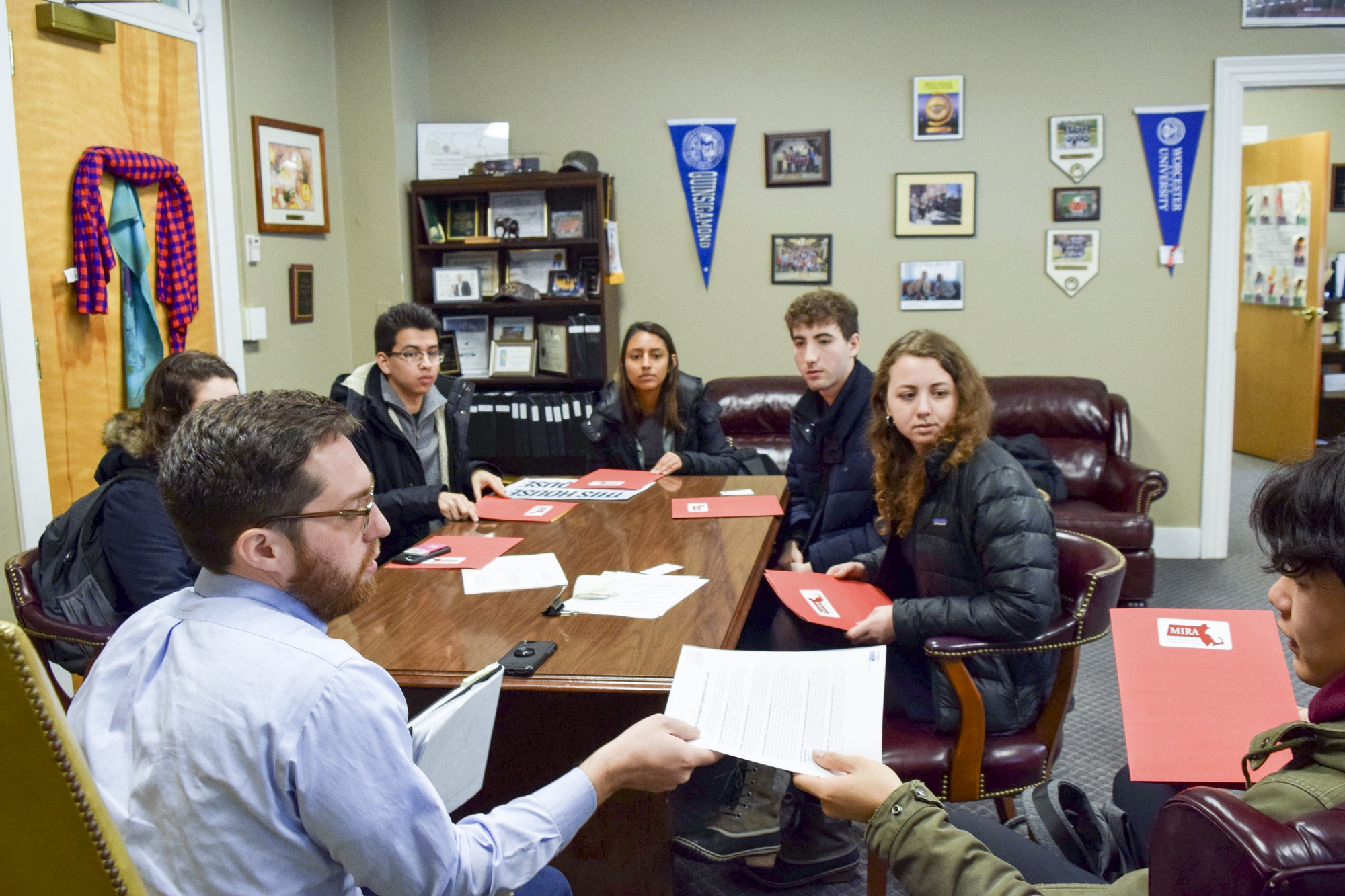 Harvard students visit state legislators at the State House on Monday to lobby for a new Safe Communities Act.
