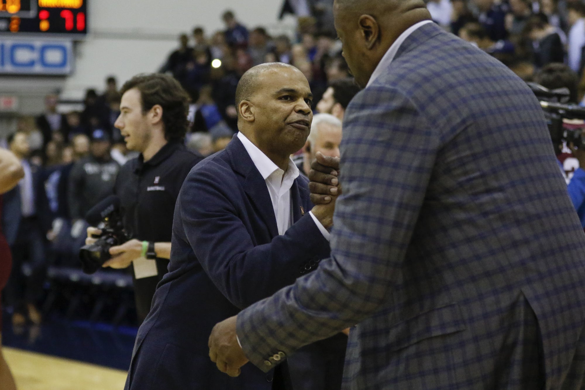 Coach Patrick Ewing and Coach Amaker embrace at the conclusion of the game.