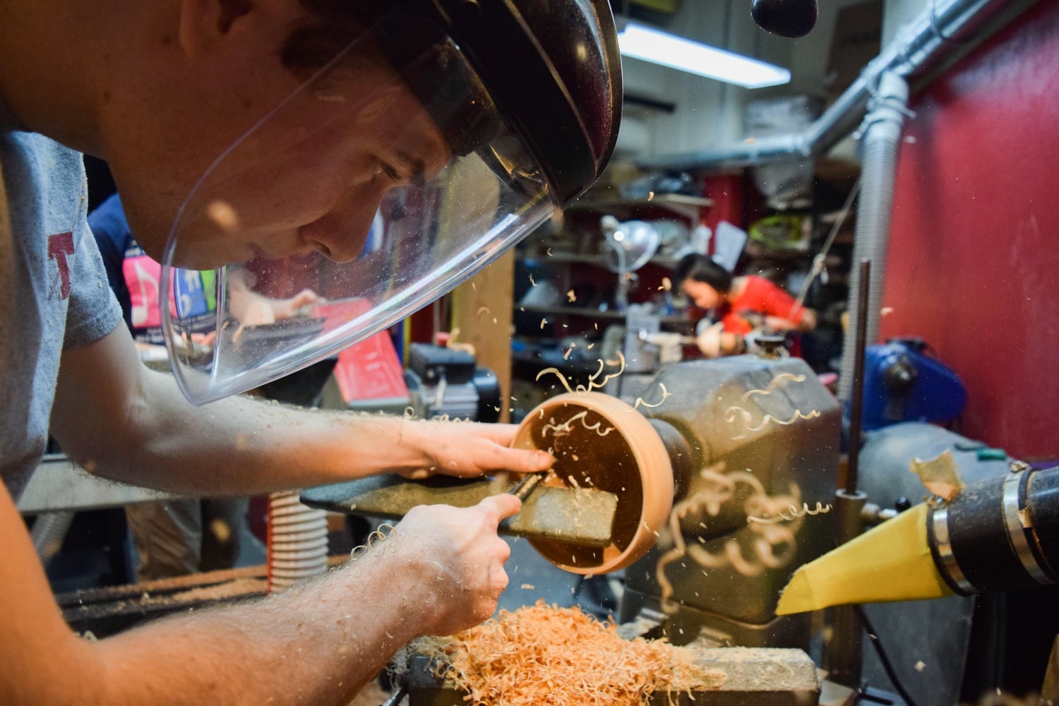 Wood shavings fly in the air as Jack B. Smith '19 hollows out the inside of his wooden bowl.