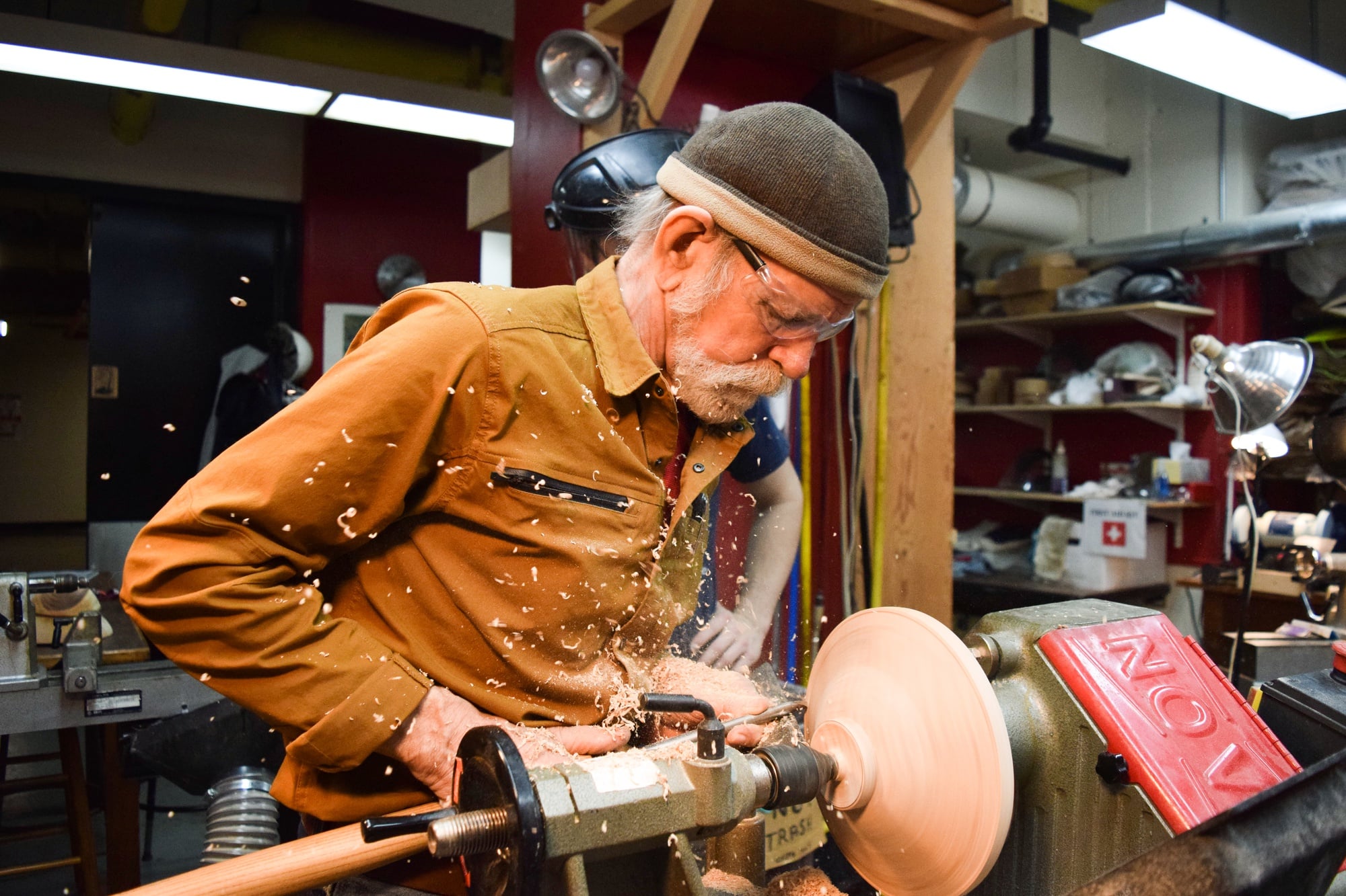 Alan Hark uses a bevel-rubbing push cut to shape a student's Bigleaf maple bowl.