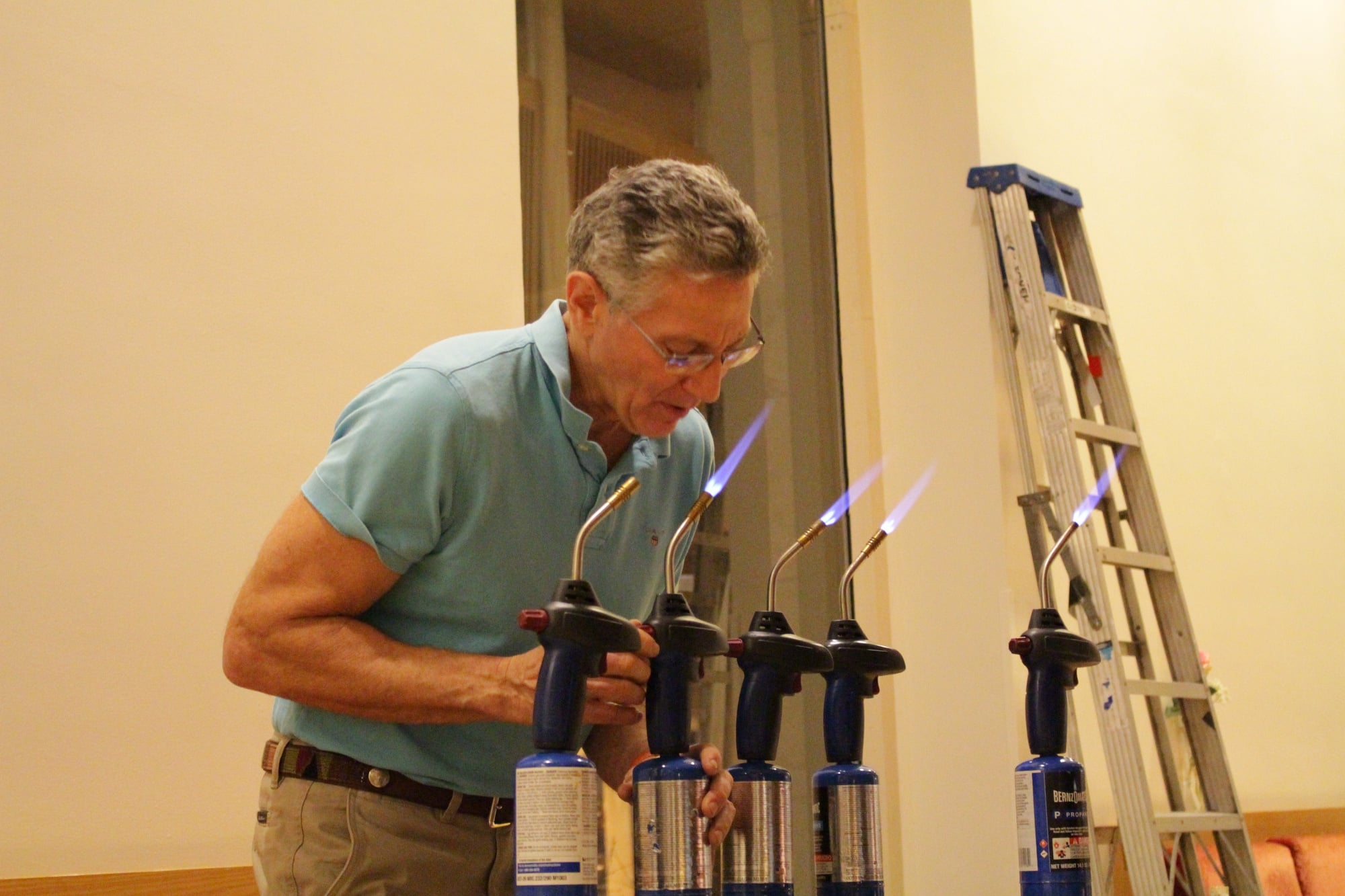 Ashrita Furman demonstrates his ability to extinguish blowtorches using only his tongue, a skill he used to break the previous Guinness World Record.