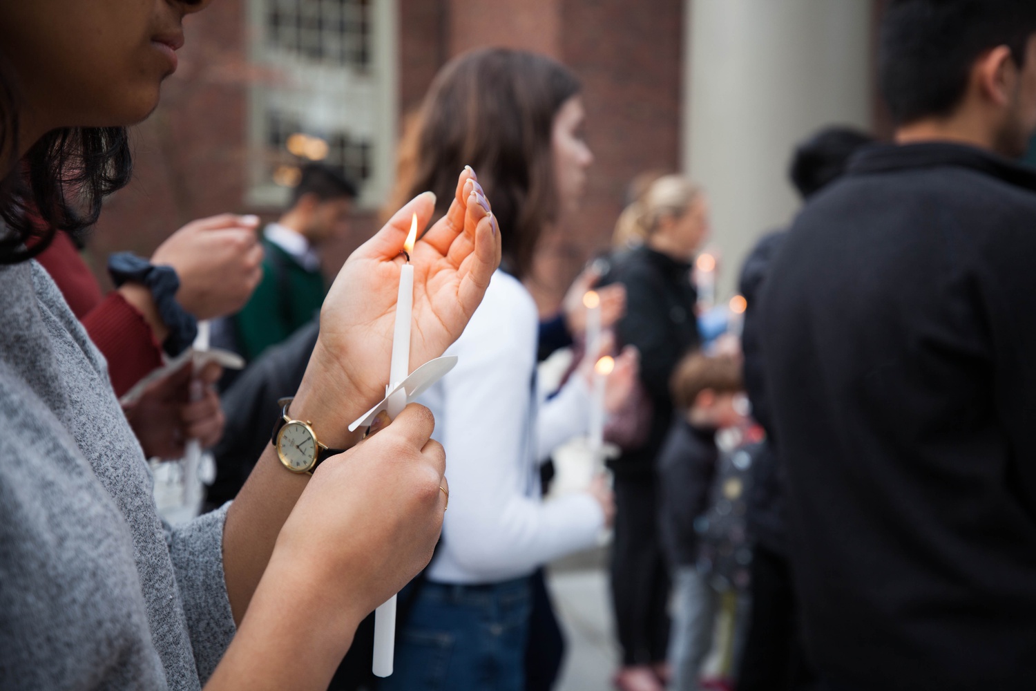 Harvard affiliates lit candles during a prayer vigil for Sri Lanka held on the steps of Memorial Church Thursday evening to remember the victims of the Easter Sunday terror attacks in Sri Lanka.