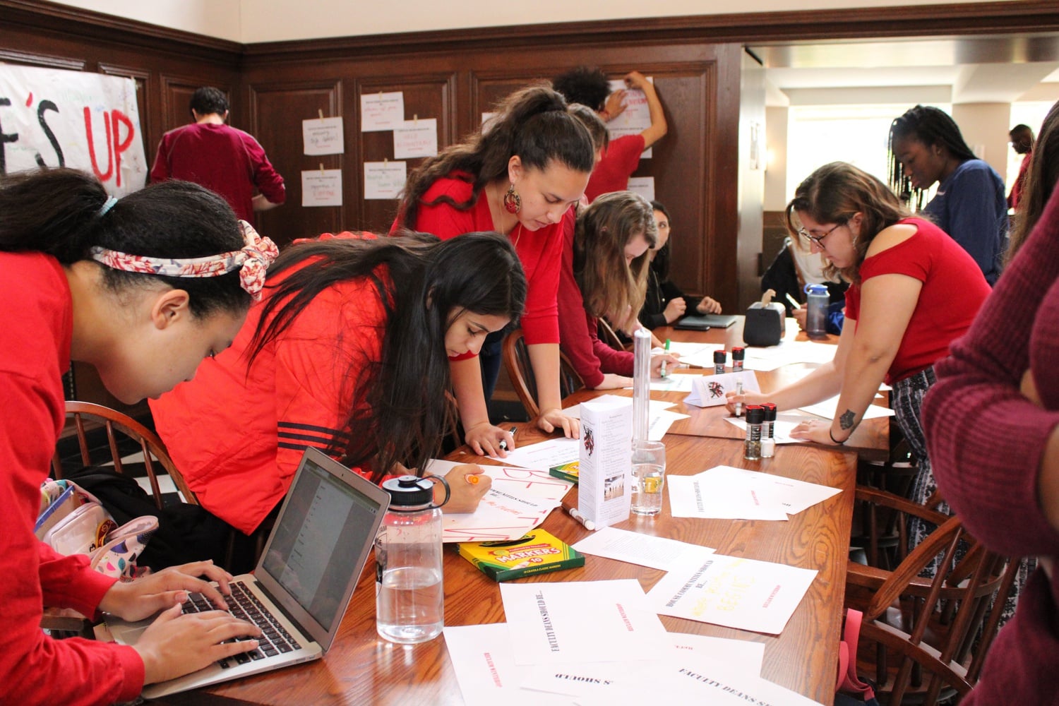Nearly 200 undergraduates wearing red sat in the Winthrop House dining hall Friday to call for administrative action months after Winthrop Dean Ronald S. Sullivan, Jr. announced his decision to represent Hollywood producer Harvey Weinstein.