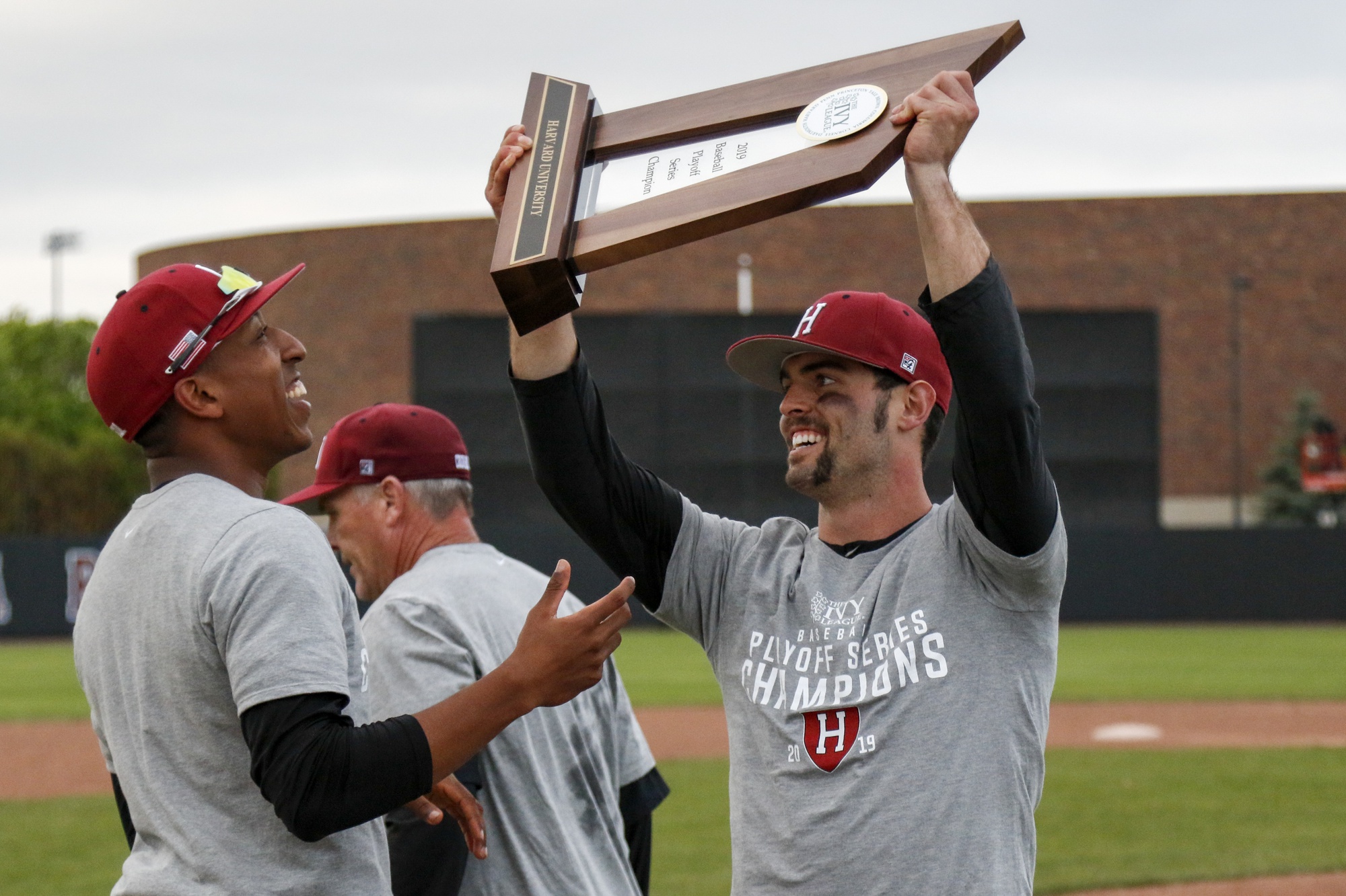 Captains Jake Allen and Chase Aldridge lift up the championship trophy.
