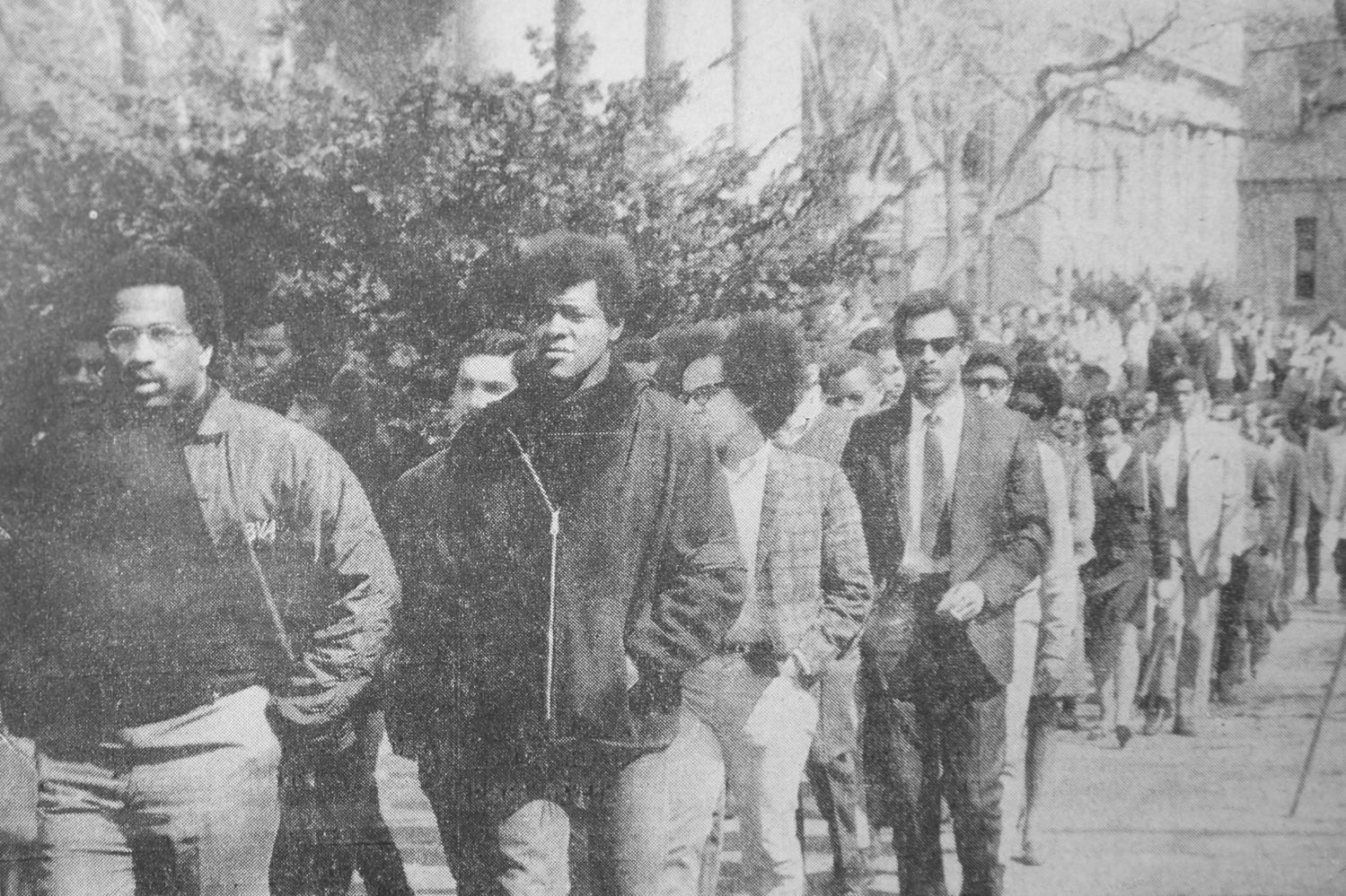 Black students leave a University memorial service for Rev. Martin Luther King Jr. to attend a separate service.