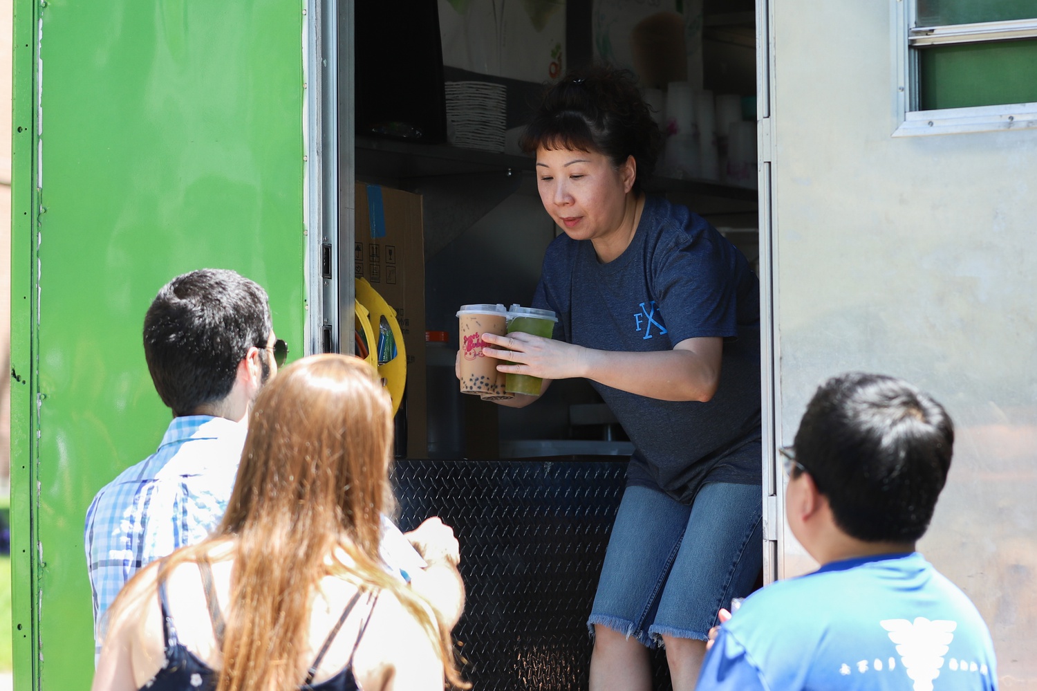 Boston Dragon Boat Festival attendees buy boba milk tea from the popular Tea Station food truck.
