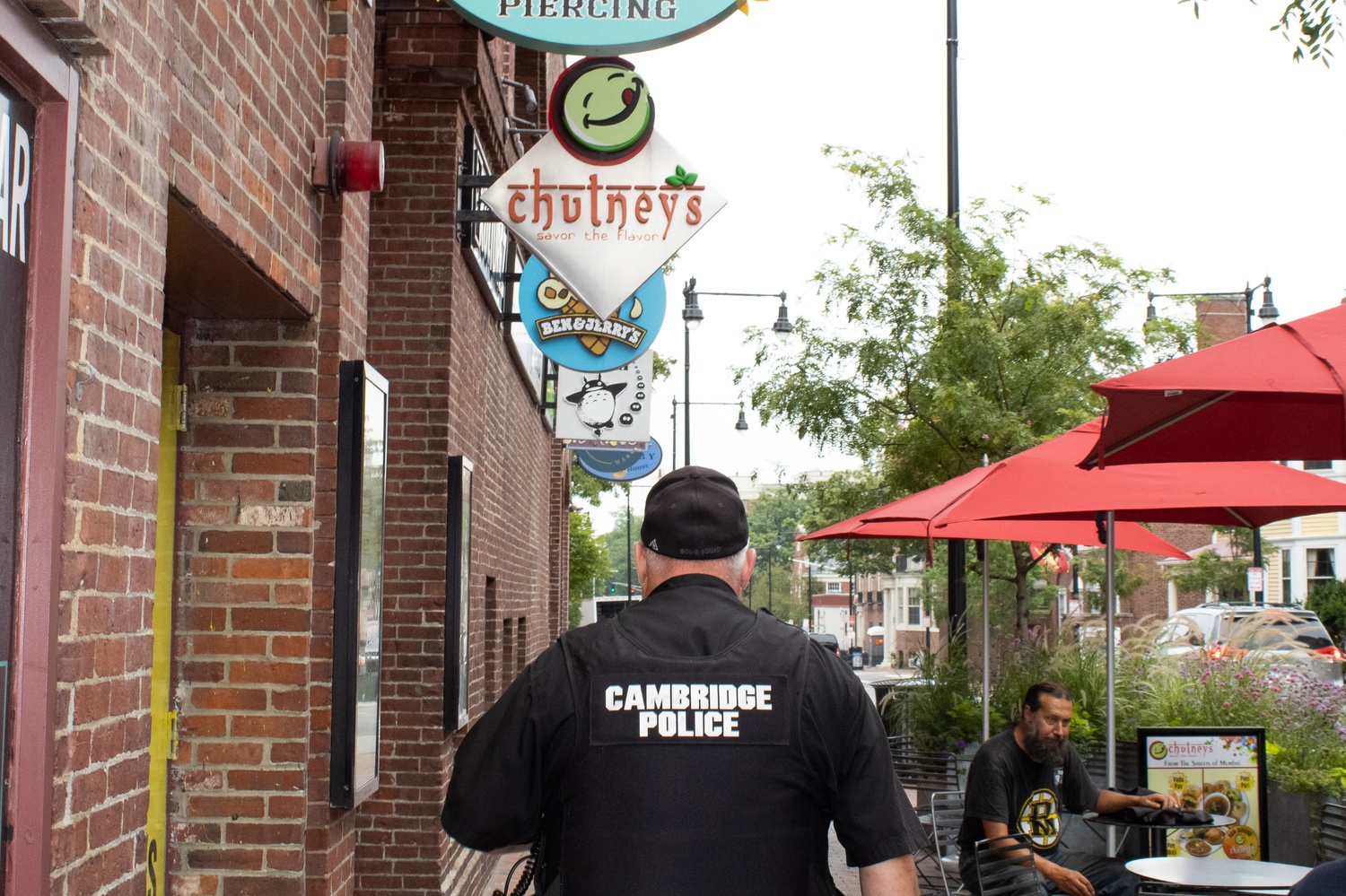 Police officers patrolled the area around the Garage — a buildng that houses stores and resturants in Harvard Square — after arresting a suspected armed man Tuesday afternoon.