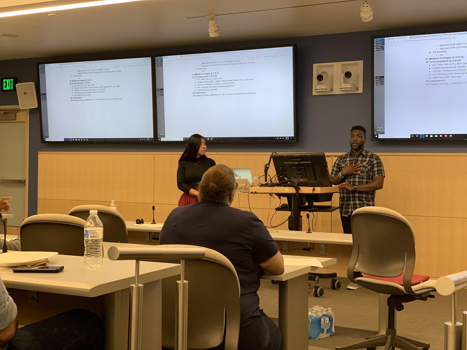 Harvard Graduate Council President Chanthia C. Ma, left, who was then the Council's Vice President, and then-President Bryan O. Buckley speak at a 2019 Council meeting.