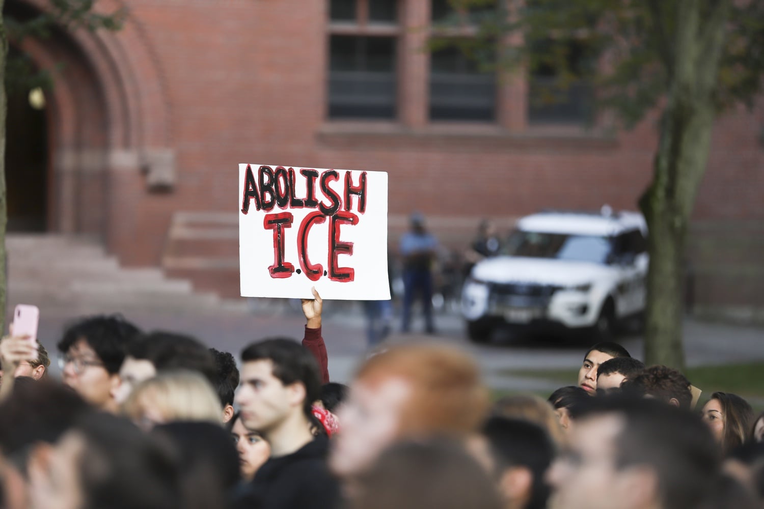 At the "Abolish ICE" rally, roughly 100 attendees hoisted signs and chanted in unison.