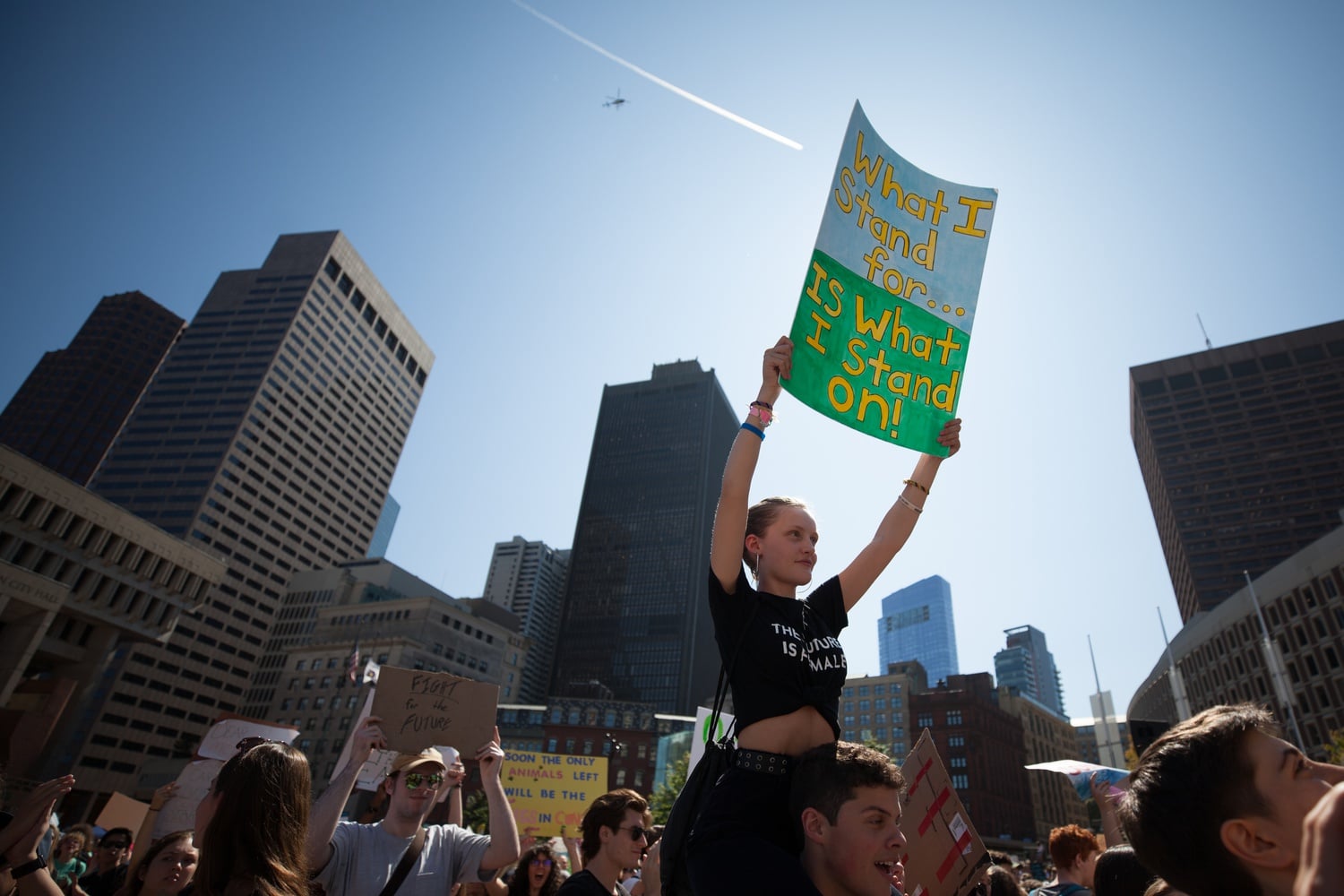 A woman holds a sign during a 2019 demonstration in Boston to call attention to climate change.
