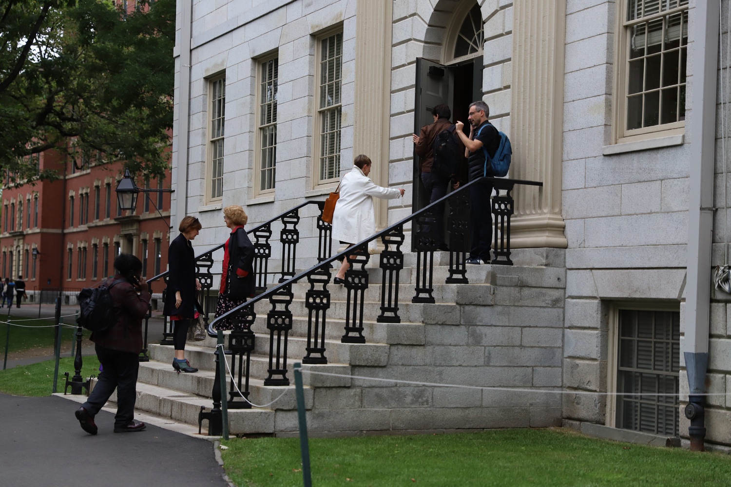 Professors and administrators walk into University Hall ahead of their monthly faculty meeting Tuesday.
