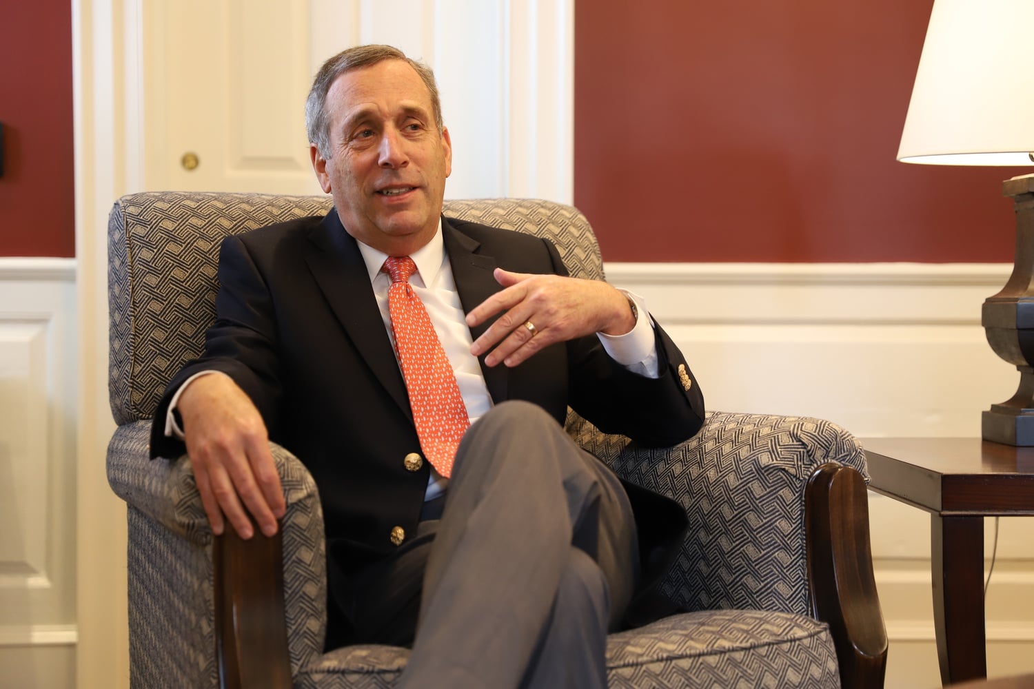University President Lawrence S. Bacow speaks with a colleague in his office in Massachusetts Hall before an October interview with The Crimson.