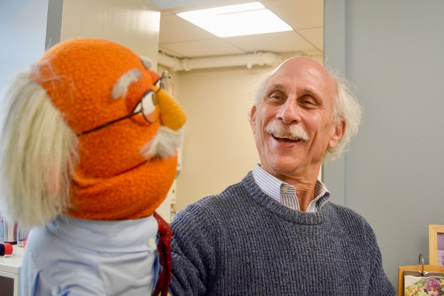 Joseph Blatt, the faculty director of the Master’s Program in Technology, Innovation and Education, laughs with his muppet in his office Friday afternoon.