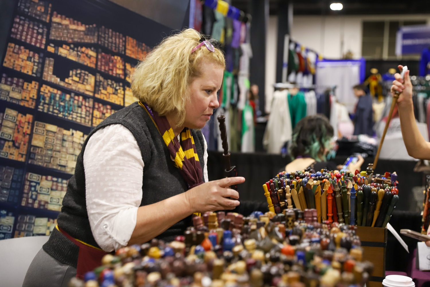 Lisa B. Laslo and her husband Greg E. Laslo opened the Hungarian Wand Shop after he carved a wand for his nephew. Their endeavour has taken them around the world selling hand-carved wands, currently attending their 9th LeakyCon.