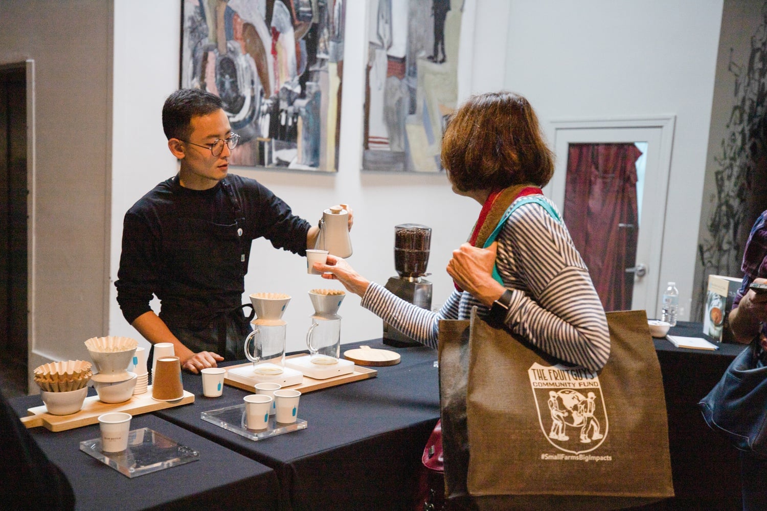 A Blue Bottle Coffee employee serves free samples at the New England Chocolate Festival.