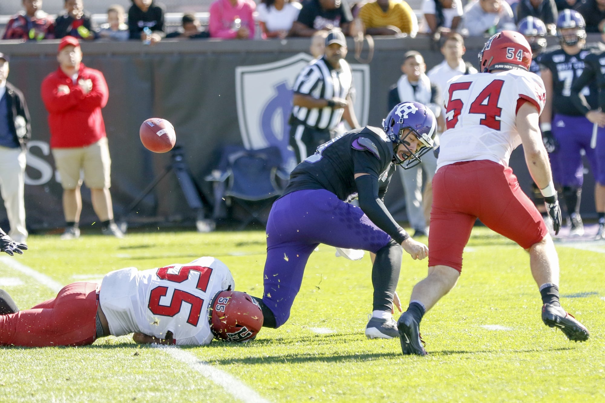 Linebacker Jordan Hill strips Crusaders quarterback Connor Degenhardt in the first quarter. Harvard recovered three forced fumbles in the first half alone.