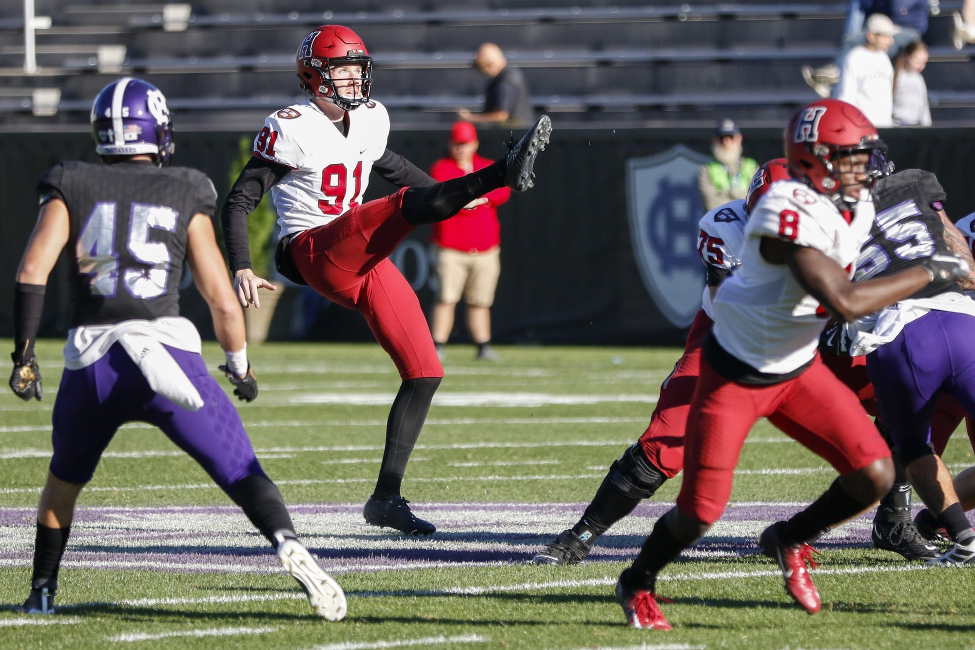 Harvard punter Sean McKeogh sends a the ball back to Holy Cross. The senior punted six time, five of which landed within the opponents 20-yard line.