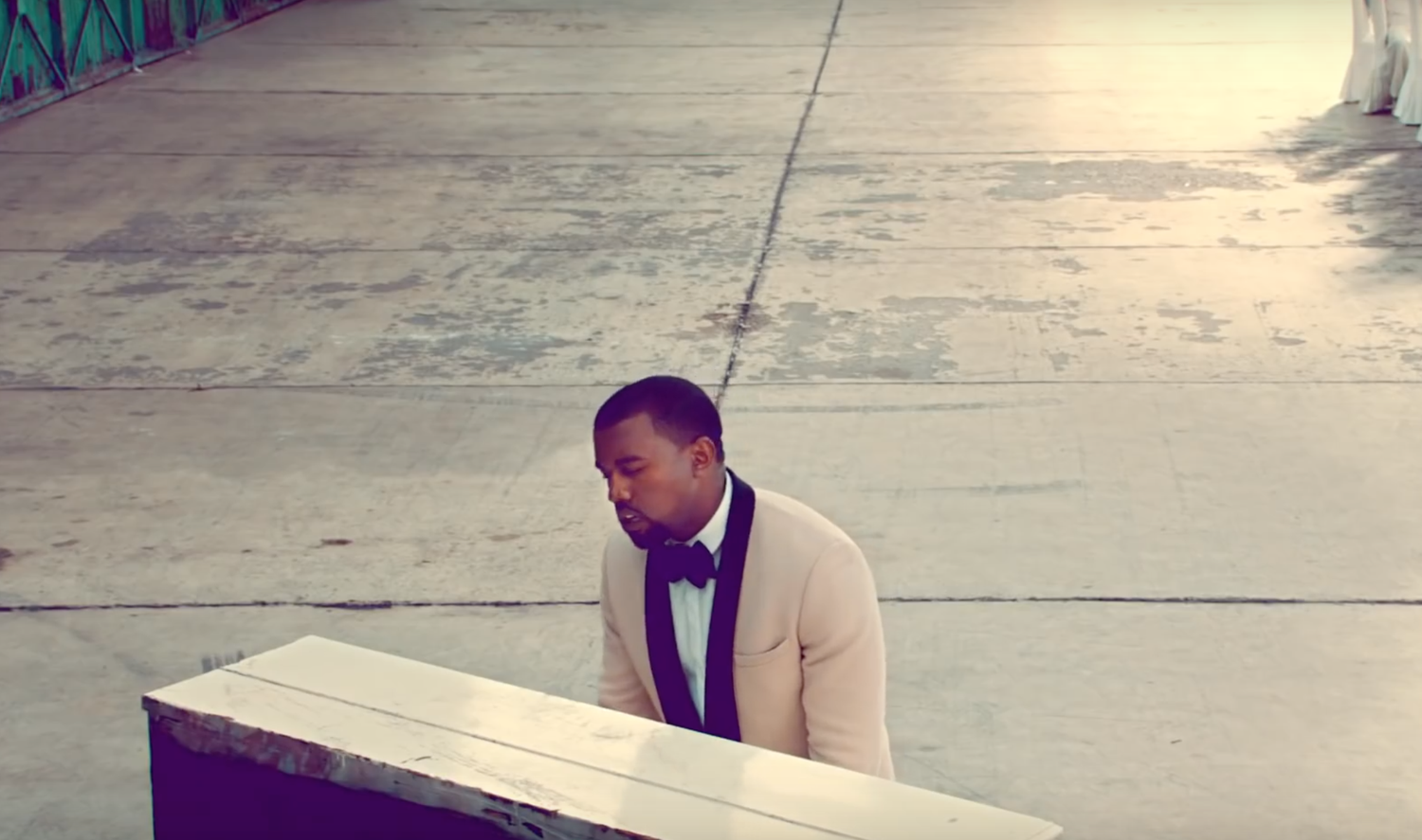 Kanye West plays piano in a short film for single "Runaway."