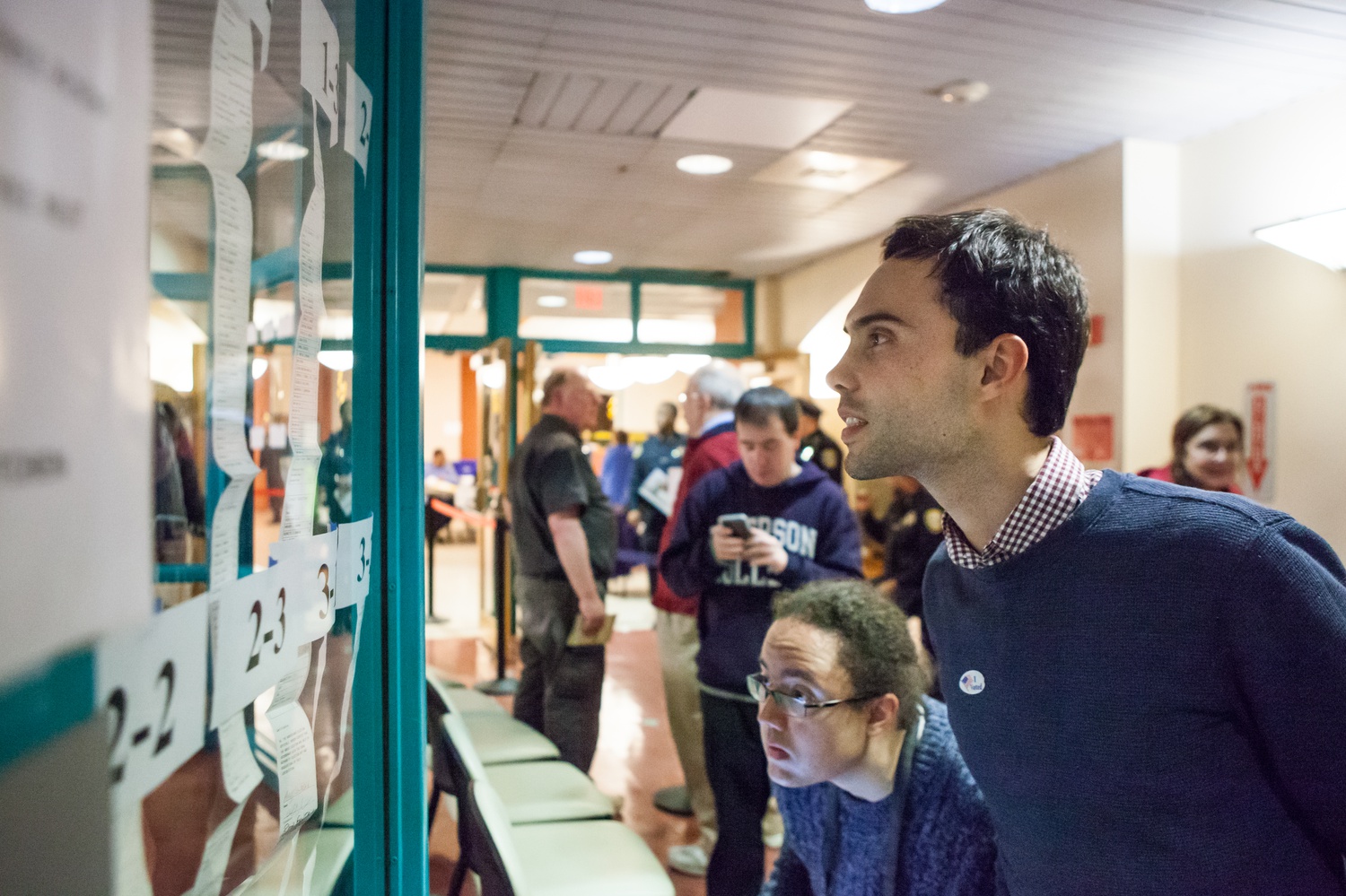 Patrick C. Braga, a student at the Graduate School of Design, checks the results for each precinct. As precincts reported to the Election Commission, the top candidates were posted in the hallway of the Cambridge Citywide Senior Center.