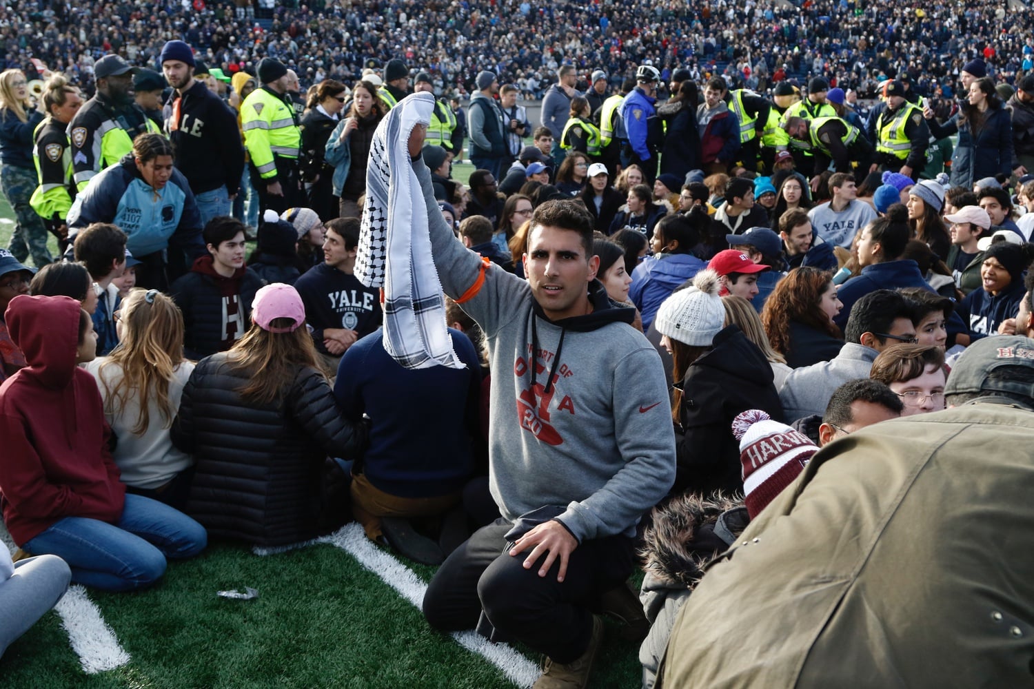 Former Palestine Solidarity Committee President Christian B. Tabash '21 raises his fist as part of the Harvard-Yale protest calling on both universities to divest their endowments from the fossil fuel industry.