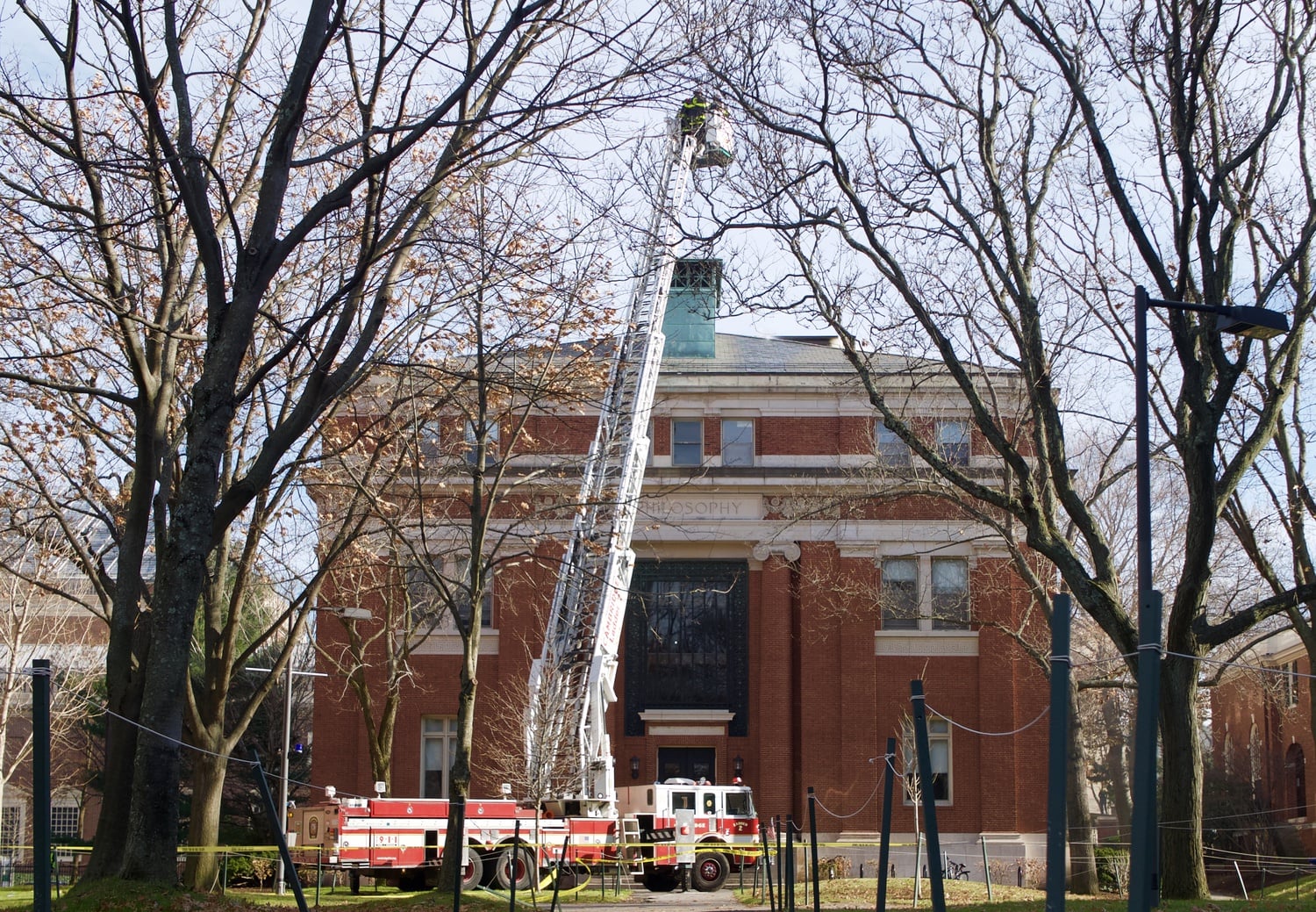 Cambridge firefighters douse the flames in Emerson Hall after smoke started pouring out of the building around noon on Friday.