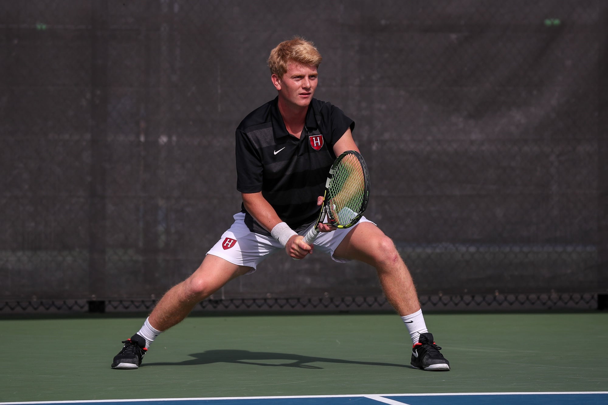 Sophomore Bo Leschly prepares to return a serve